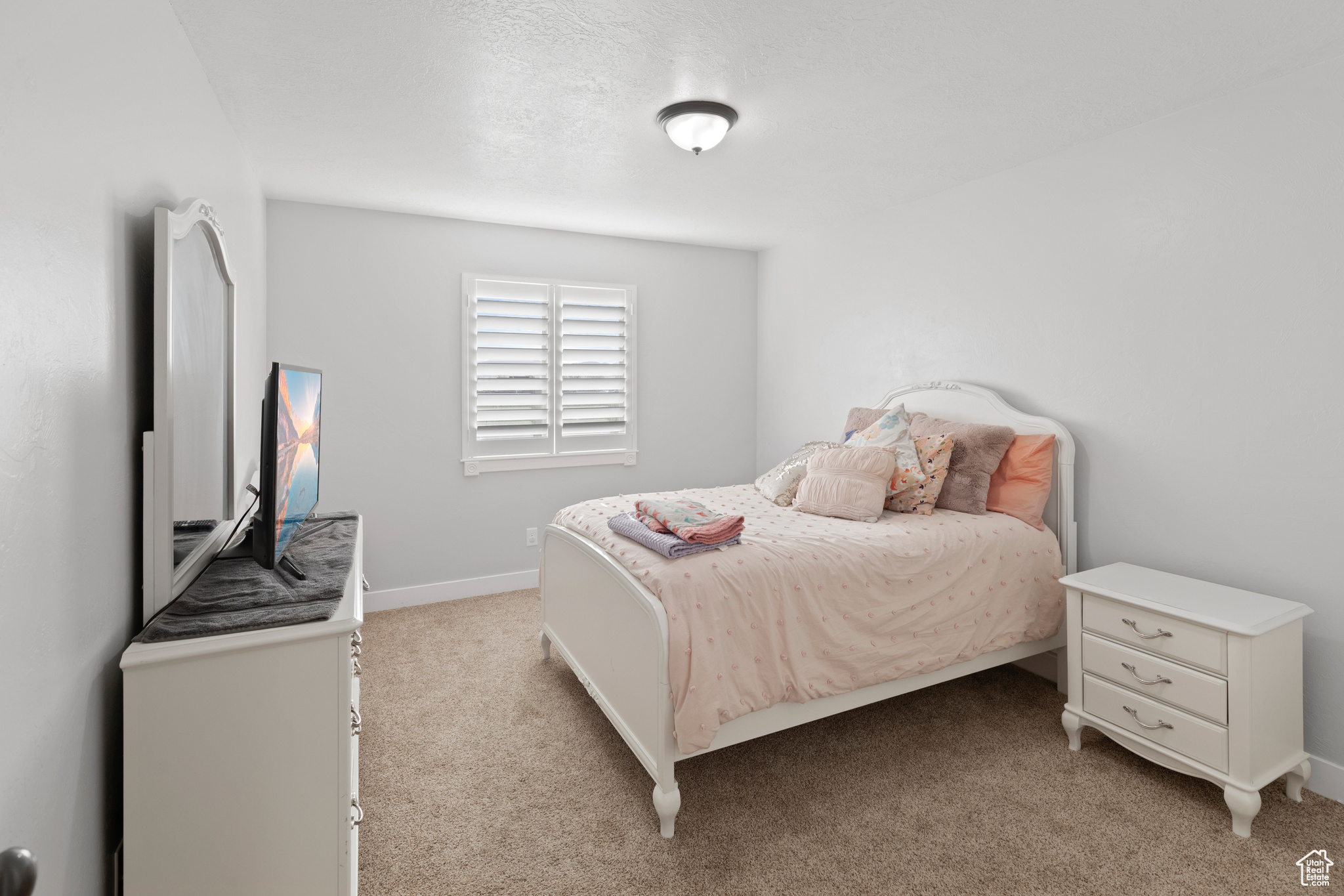 Bedroom with light colored carpet