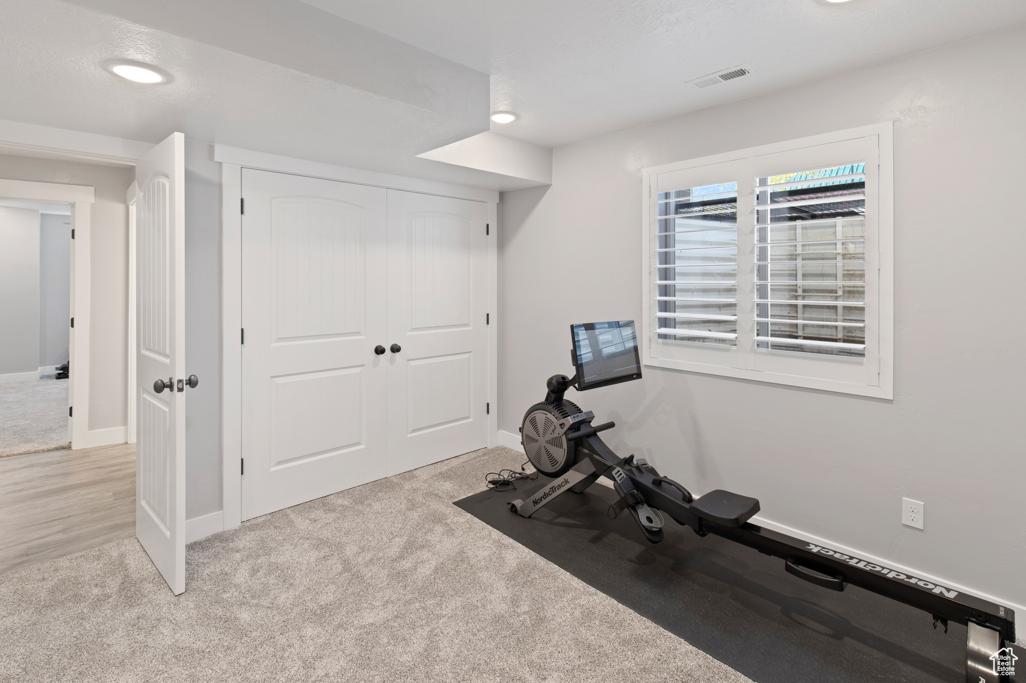 Workout room featuring light hardwood / wood-style floors