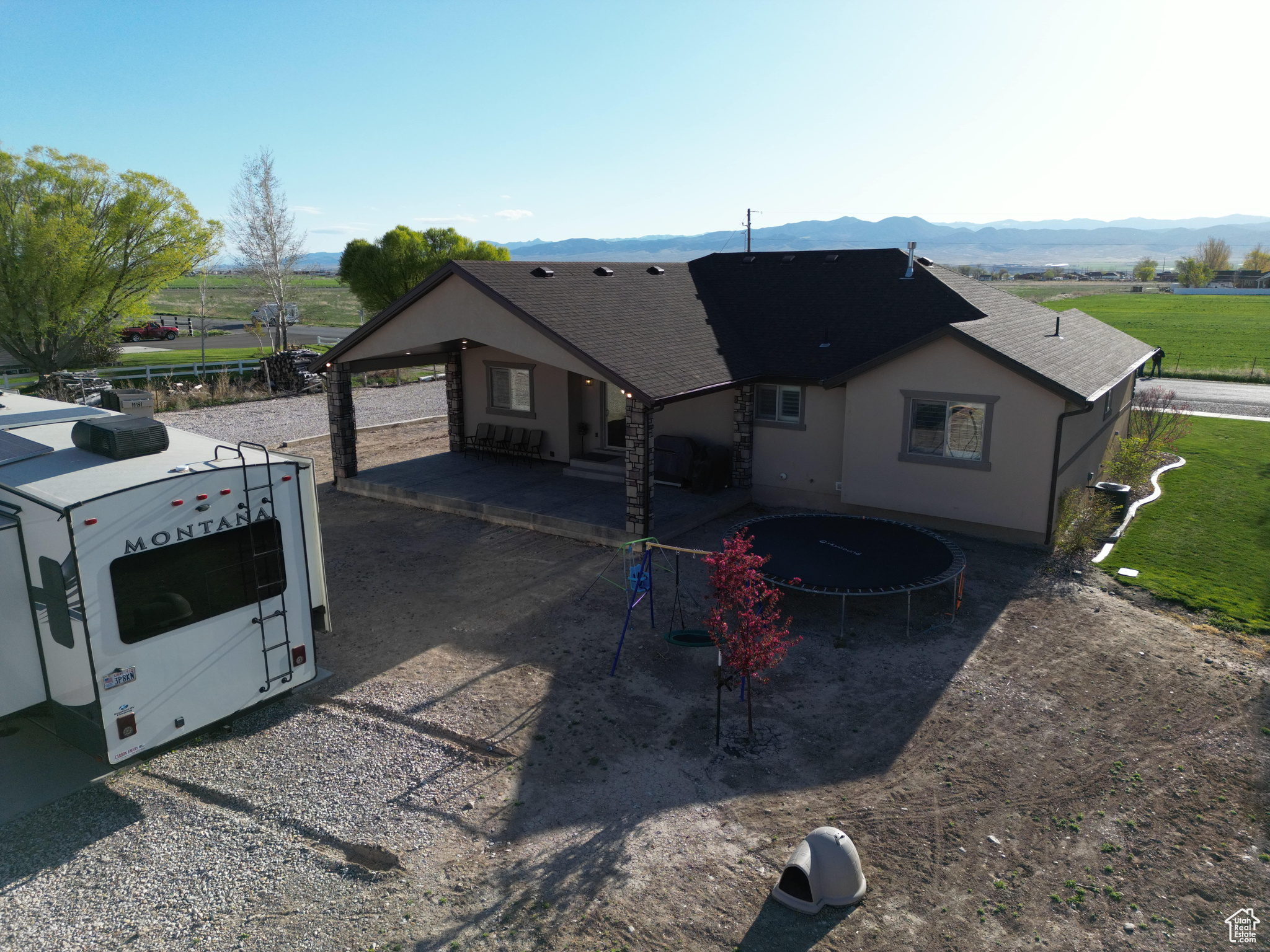 Back of house featuring a trampoline