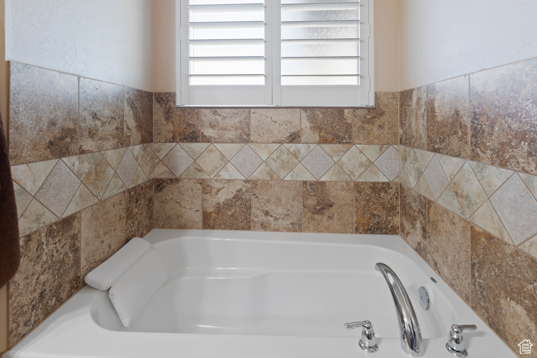 Bathroom featuring a bath and a healthy amount of sunlight