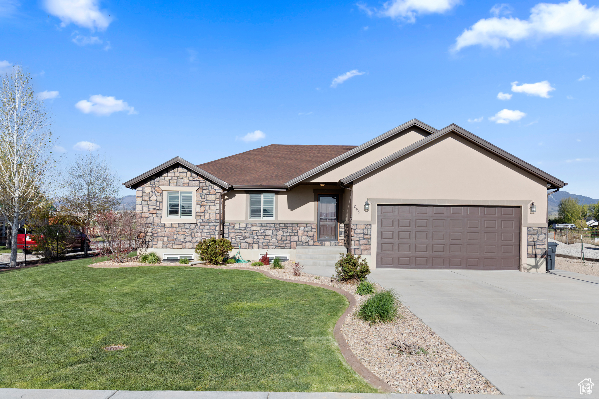 Single story home with a front lawn and a garage