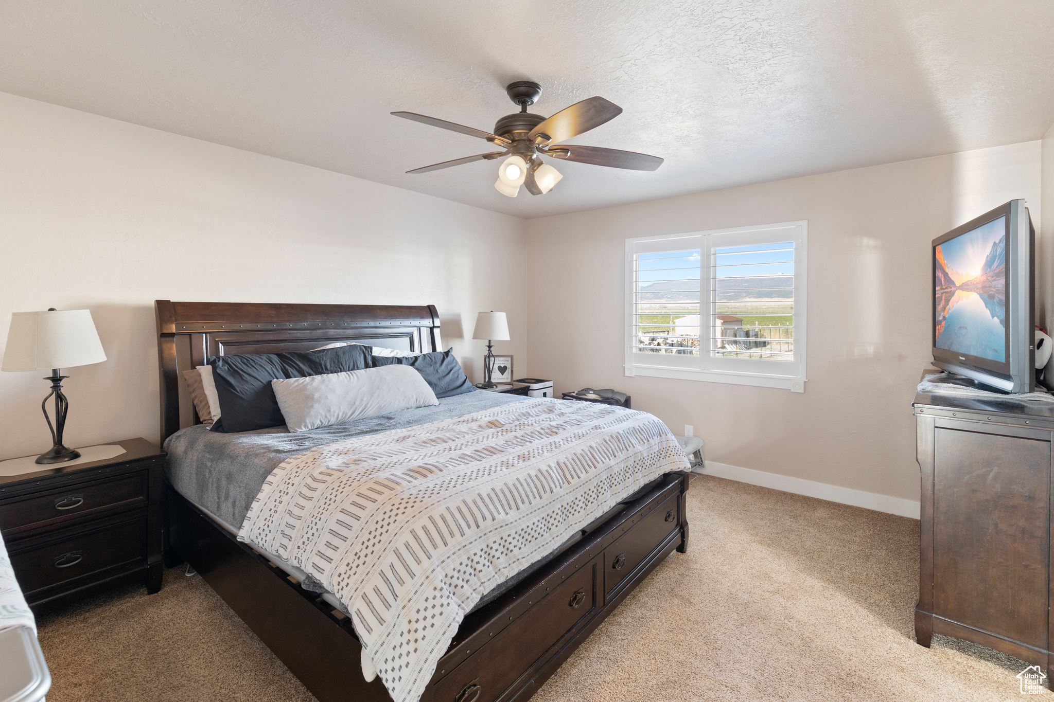 Bedroom featuring light colored carpet and ceiling fan