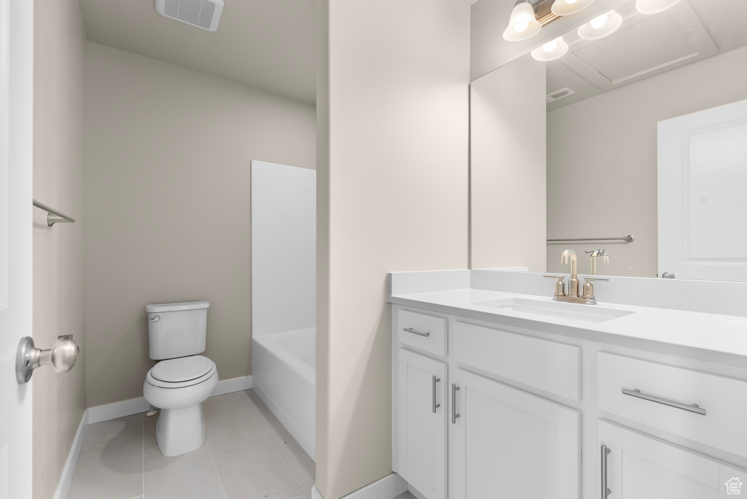Full bathroom with tile floors, washtub / shower combination, toilet, and vanity