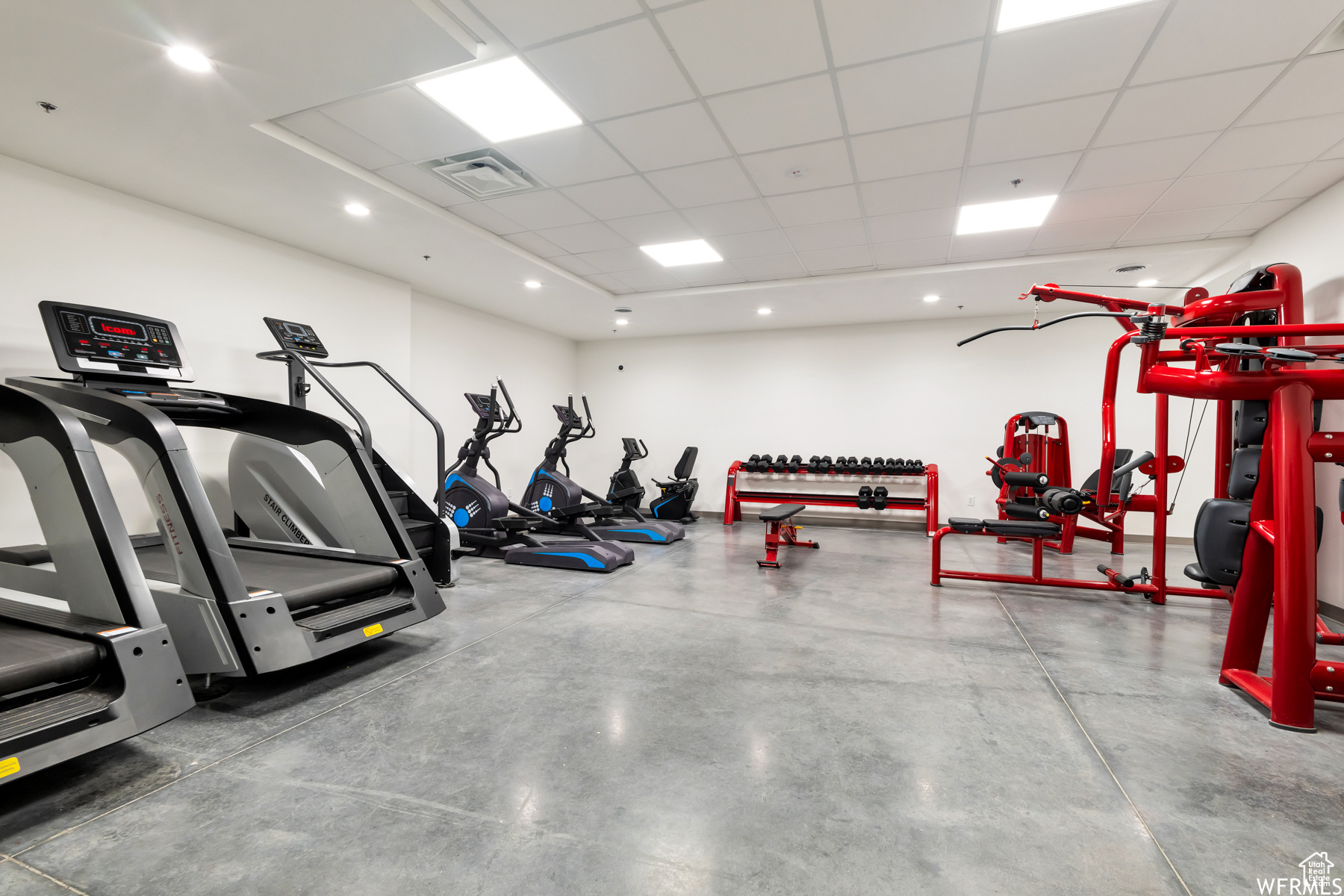 Workout area with a drop ceiling and concrete flooring