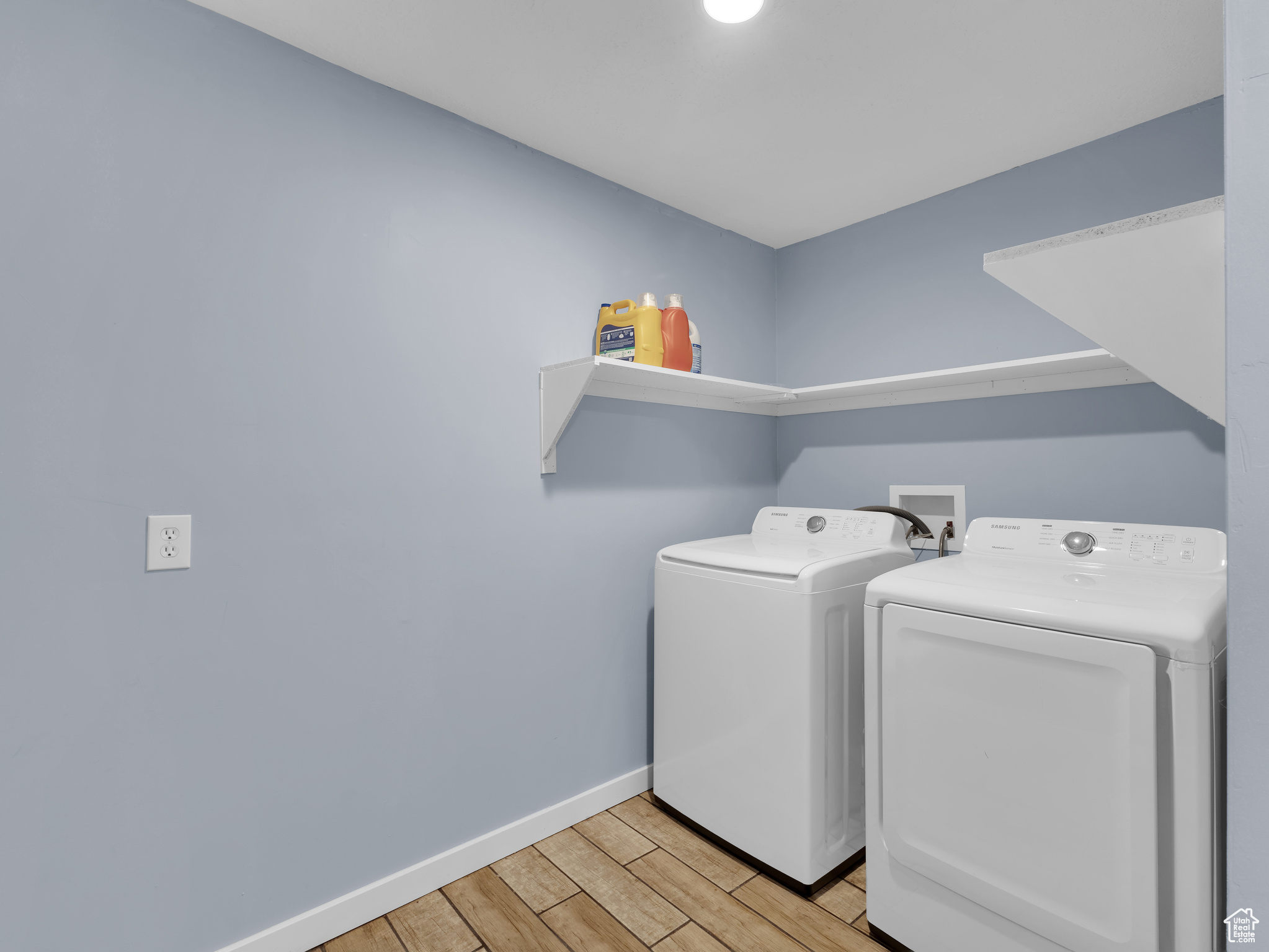 Laundry area featuring light hardwood / wood-style flooring, separate washer and dryer, and washer hookup