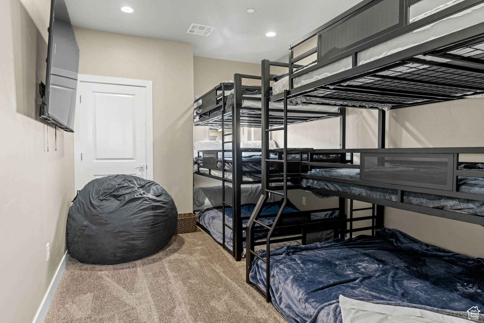 Bedroom featuring light carpet