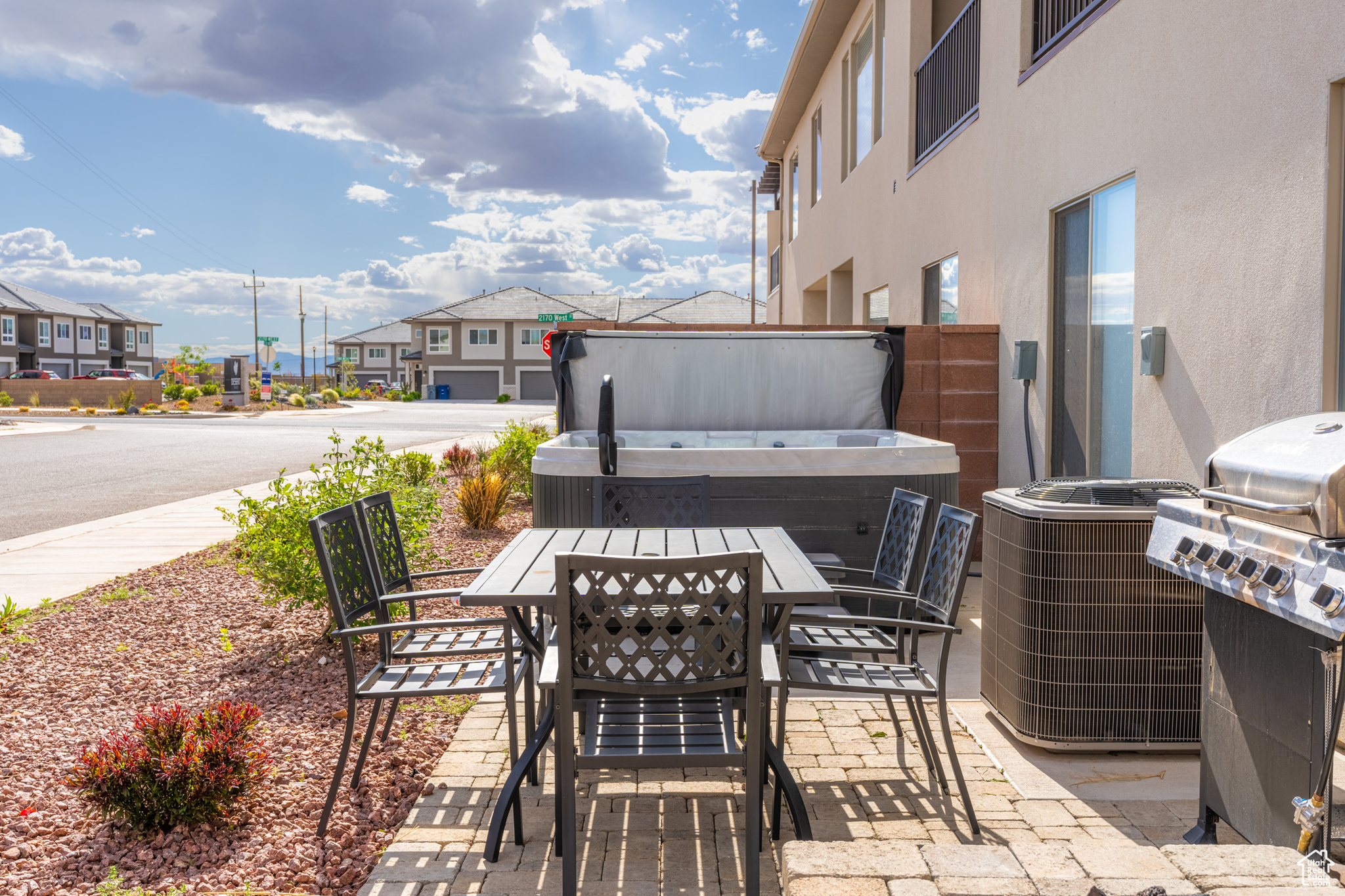 View of patio with central air condition unit and a covered hot tub