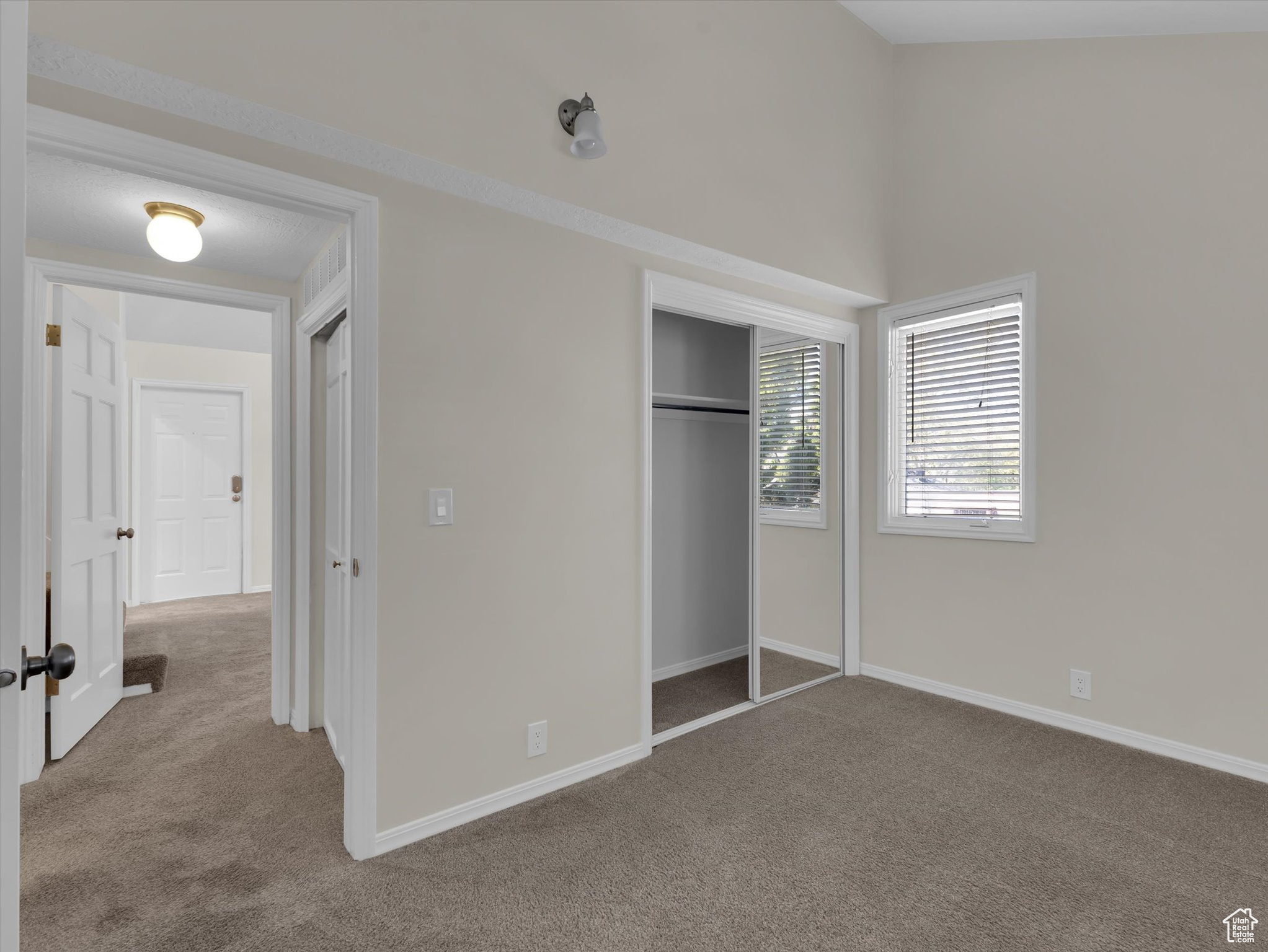 Unfurnished bedroom featuring a closet and carpet floors