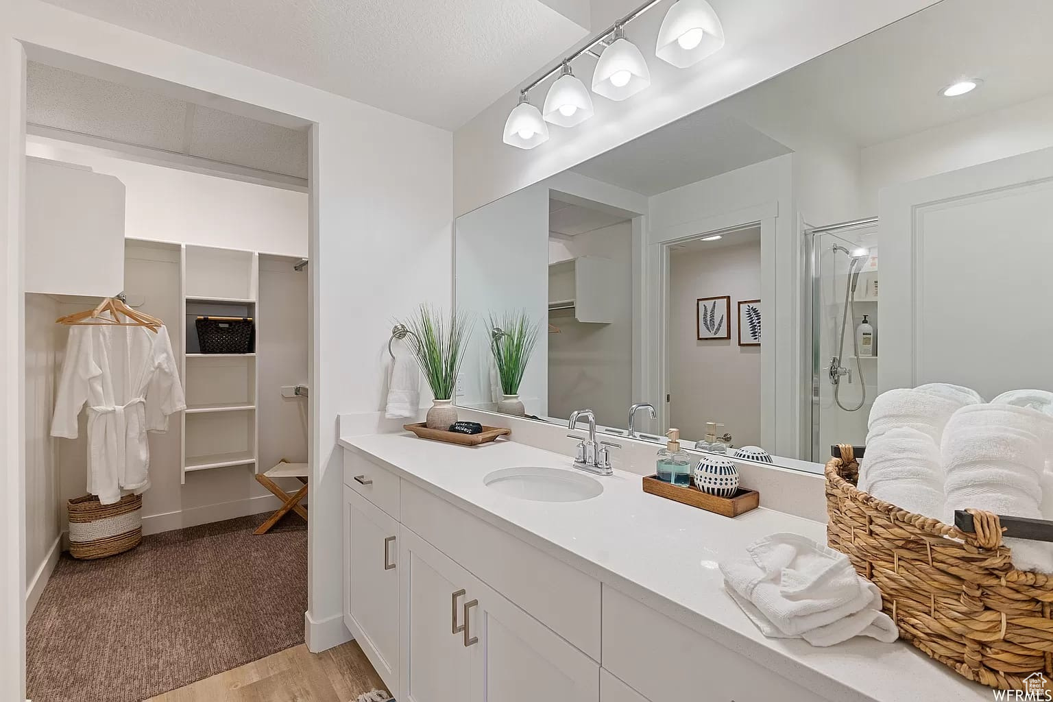 Ensuite Bathroom featuring a shower and large vanity