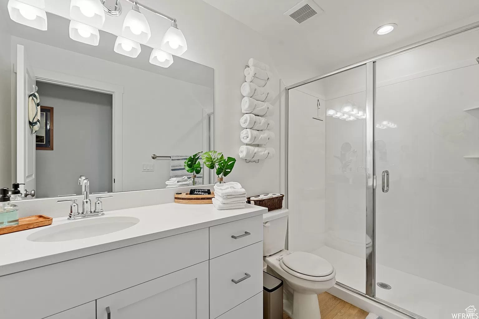 Bathroom with shower, toilet, and vanity