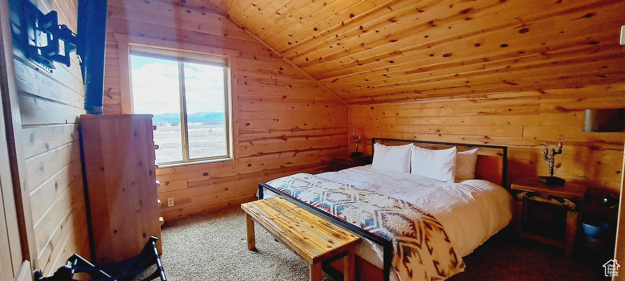 Bedroom with wooden ceiling, vaulted ceiling, and multiple windows