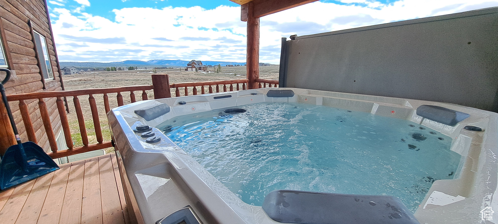 View of pool with a mountain view and an outdoor hot tub