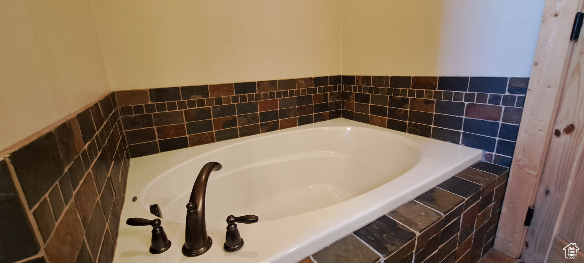 Bathroom featuring tiled bath