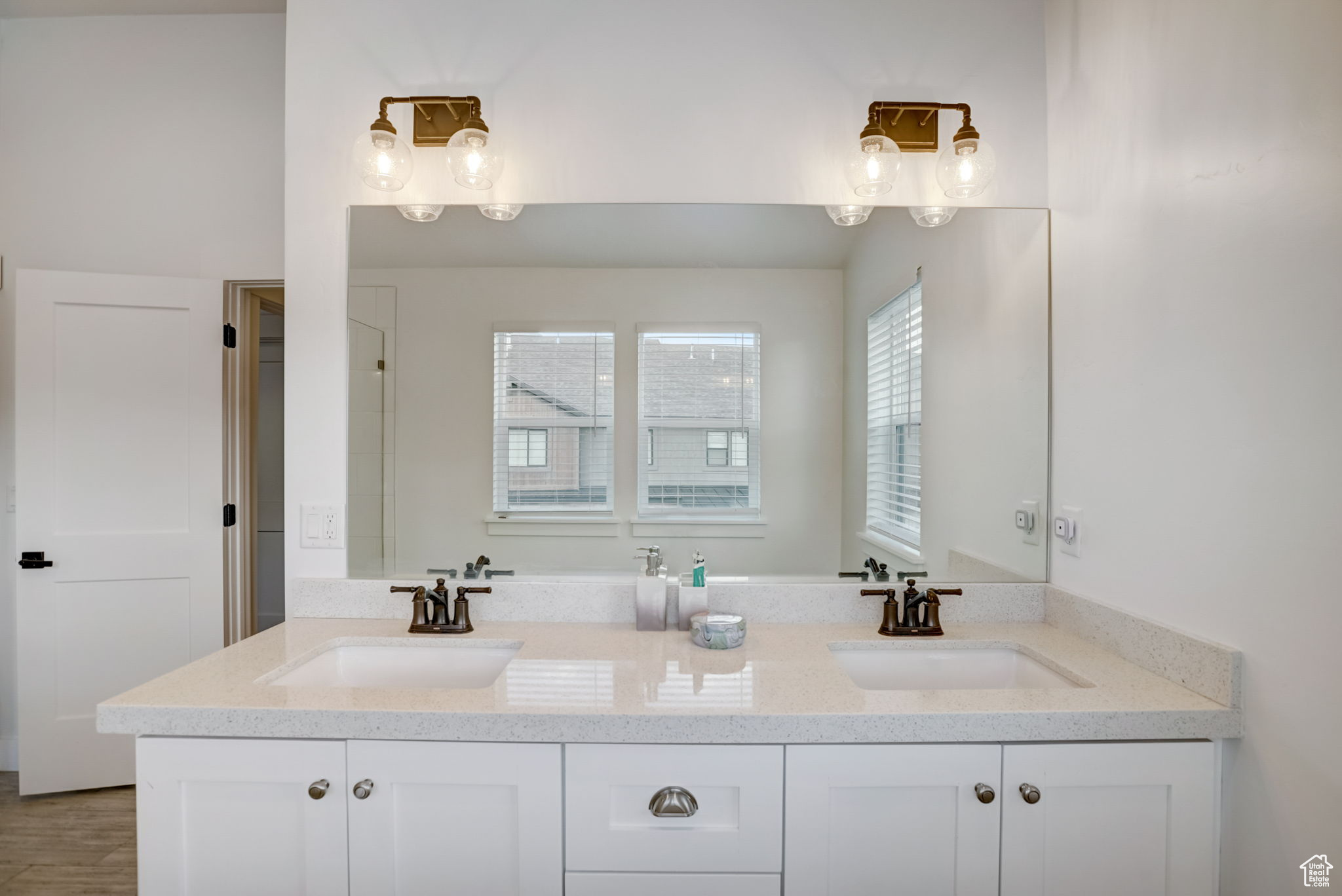 Bathroom featuring hardwood / wood-style floors and dual bowl vanity