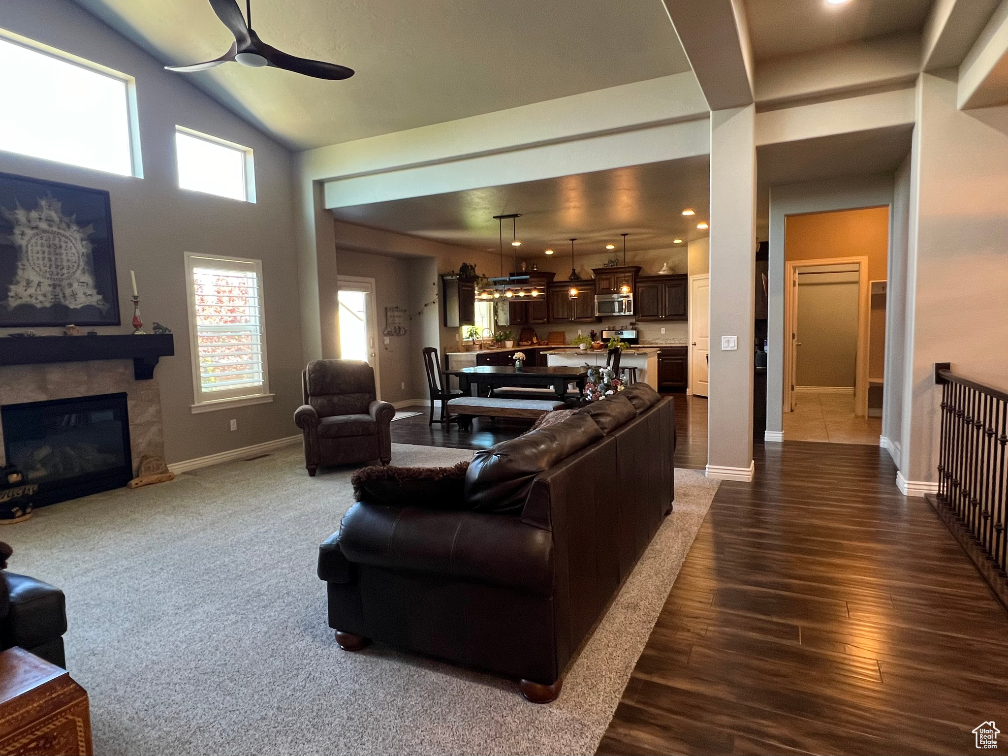 Great room featuring  wood-style flooring, ceiling fan, and vaulted ceiling