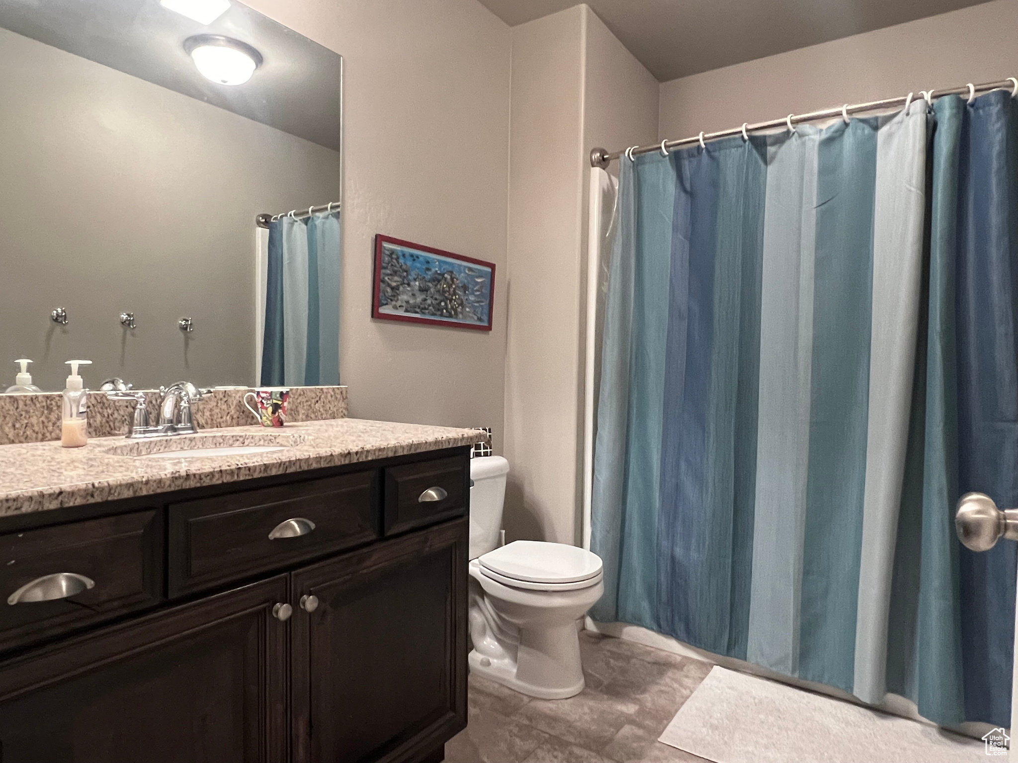 Basement Bathroom with vanity, toilet, and tile flooring