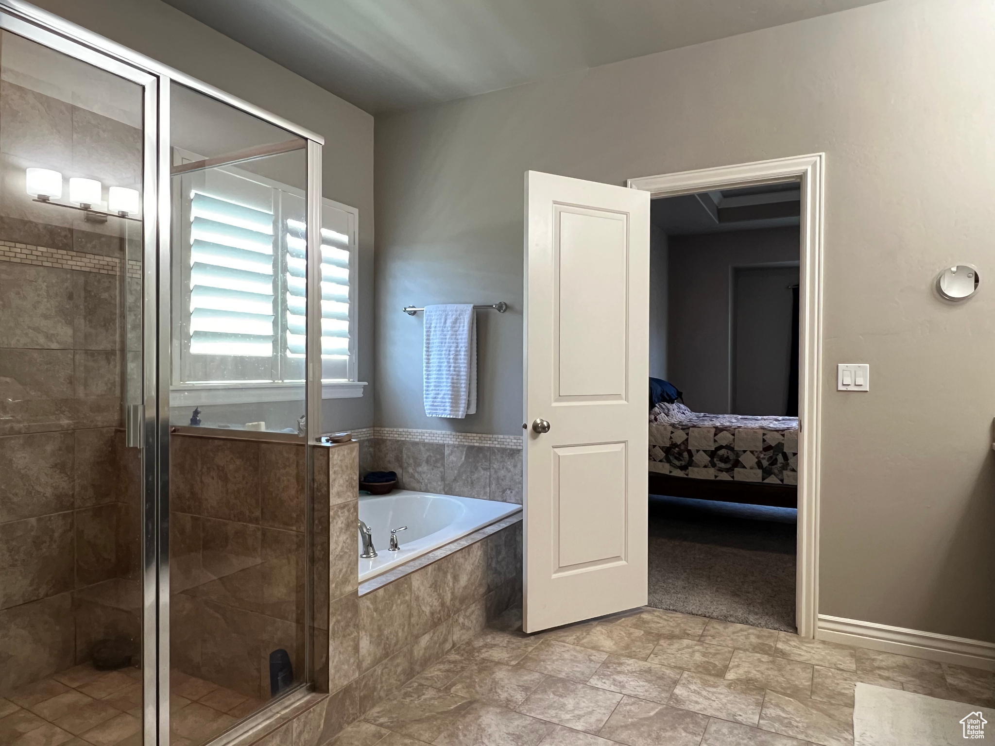 Main Bathroom featuring tile flooring and shower with separate bathtub