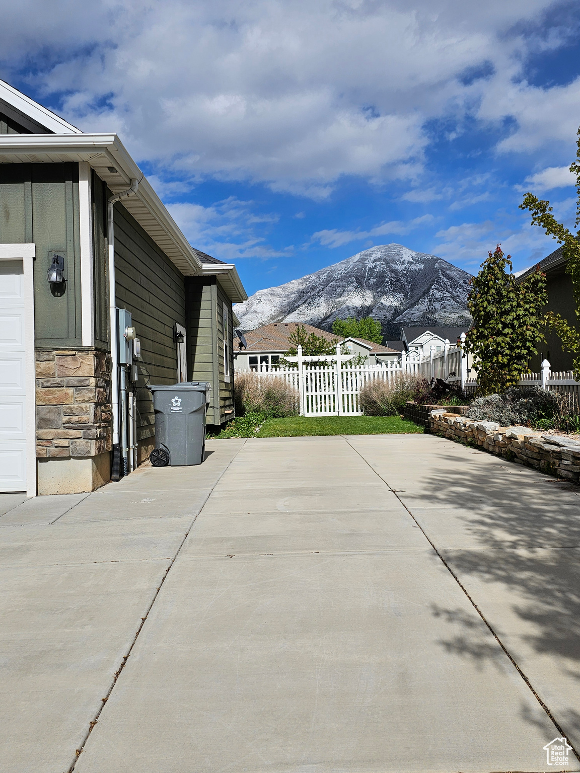 View of side of property featuring a patio area and a mountain view