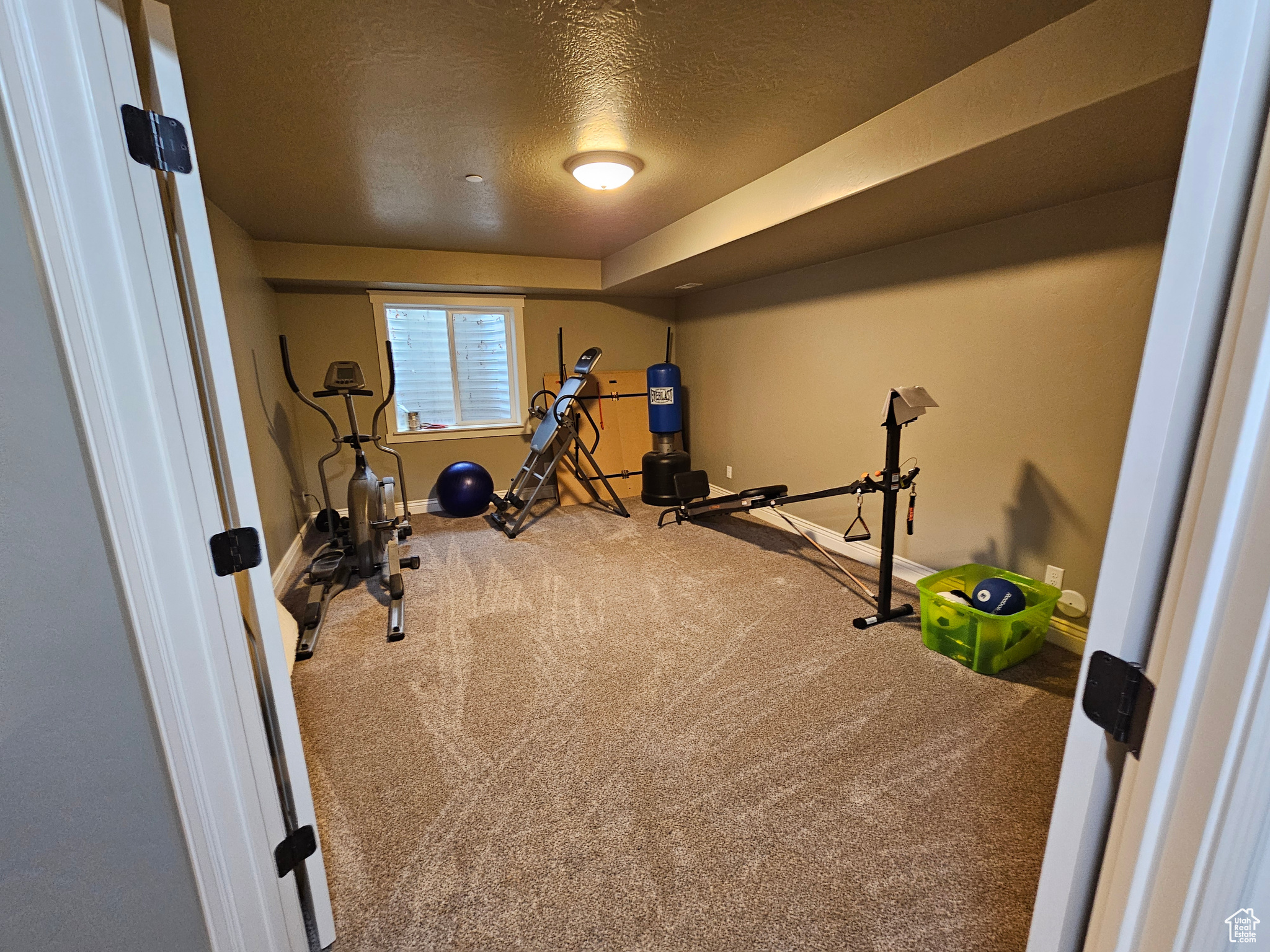 Exercise area with carpet and a textured ceiling