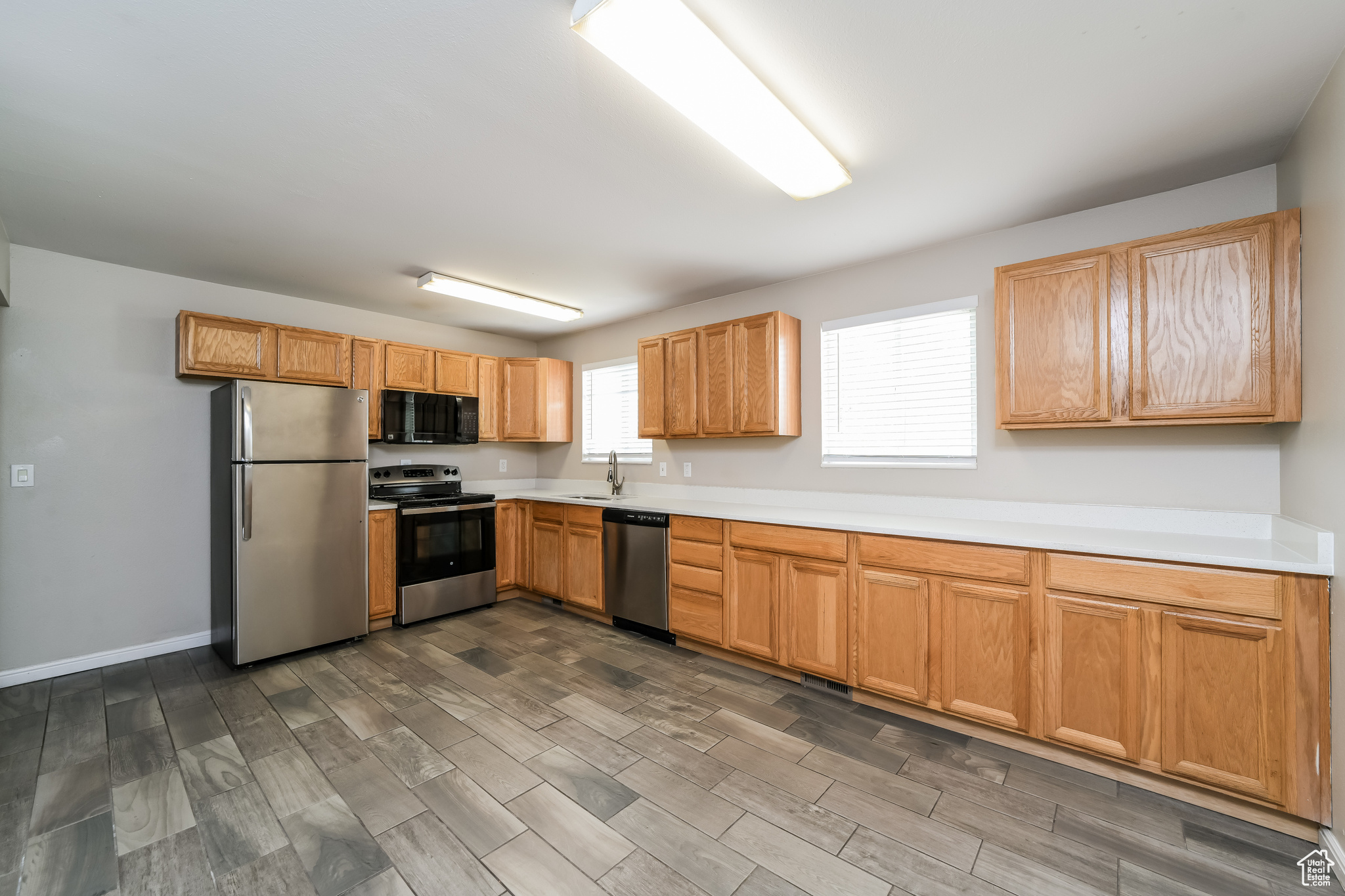 Kitchen featuring stainless steel appliances, hardwood / wood-style floors, and sink