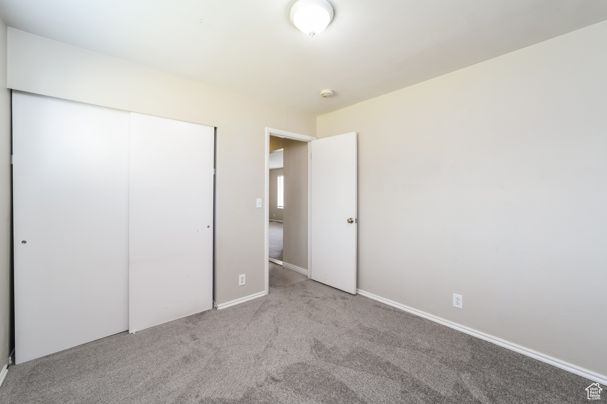 Unfurnished bedroom featuring carpet and a closet