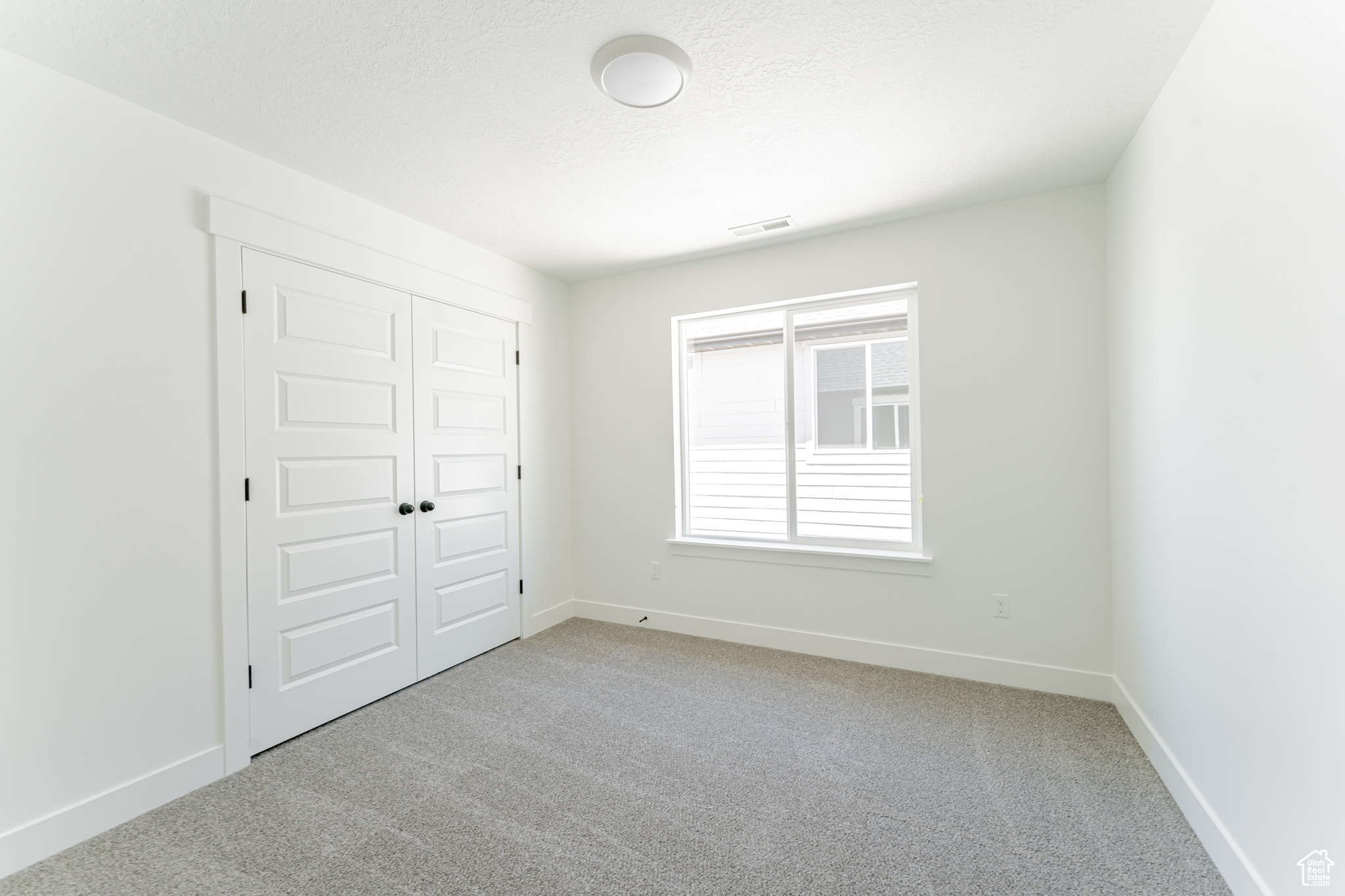 Unfurnished bedroom featuring carpet floors and a closet