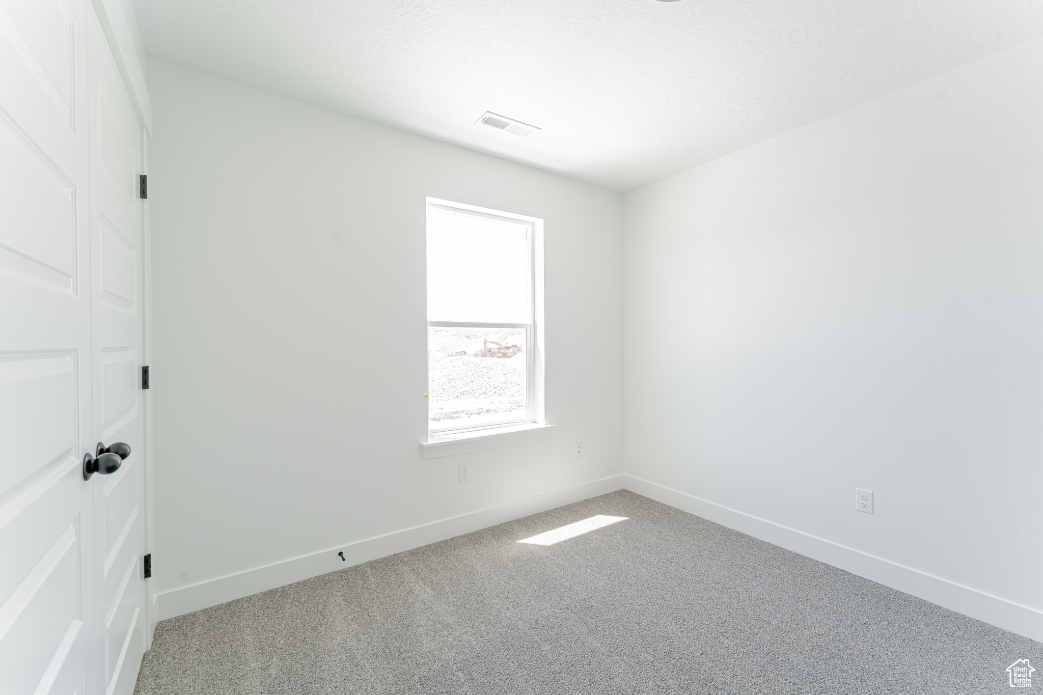 Empty room with carpet flooring