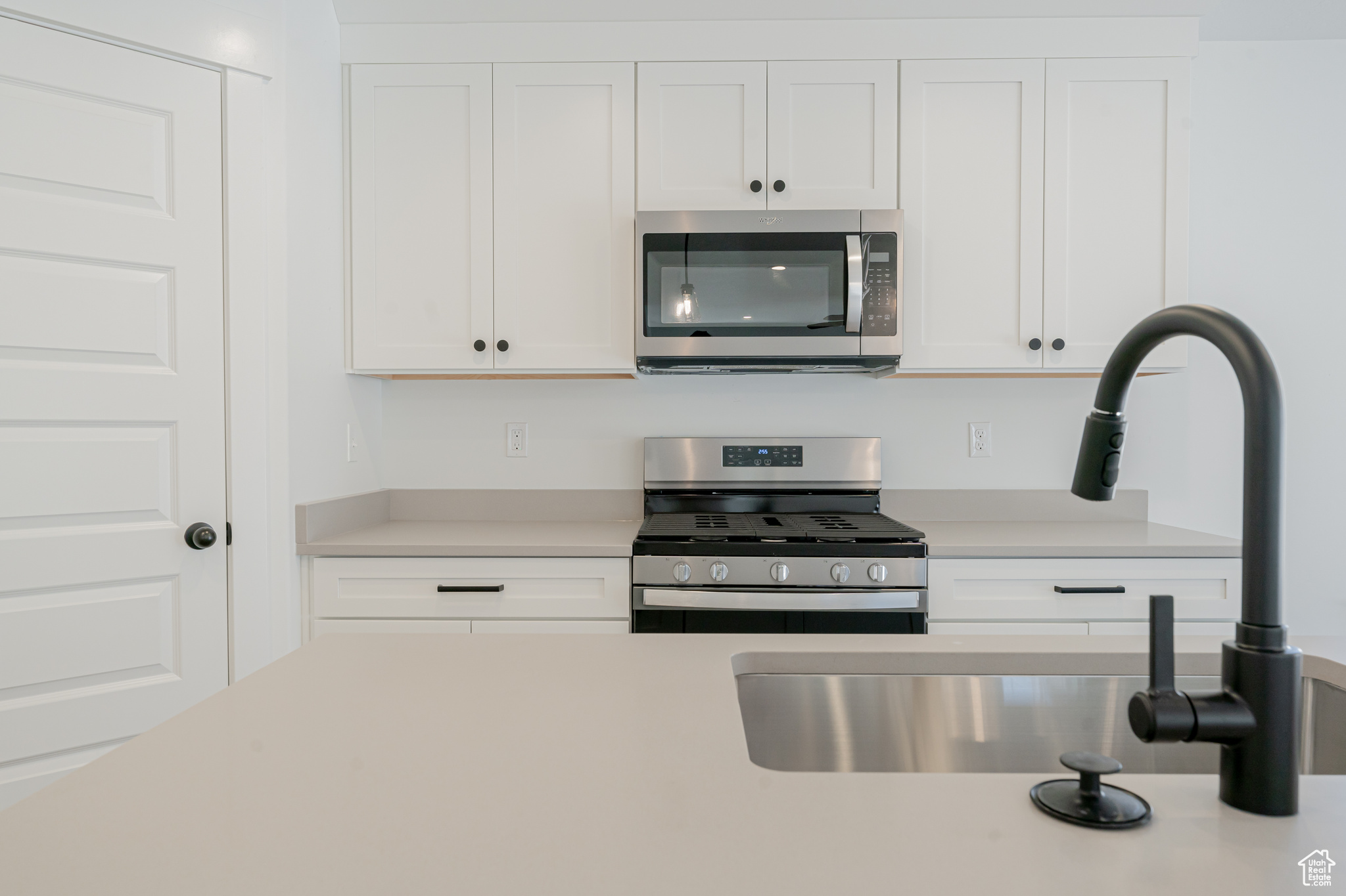 Kitchen with white cabinets and stainless steel appliances