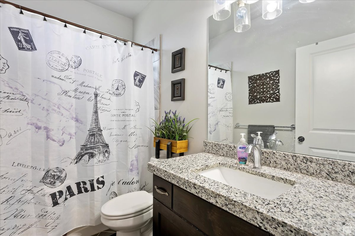 Bathroom featuring large vanity and toilet