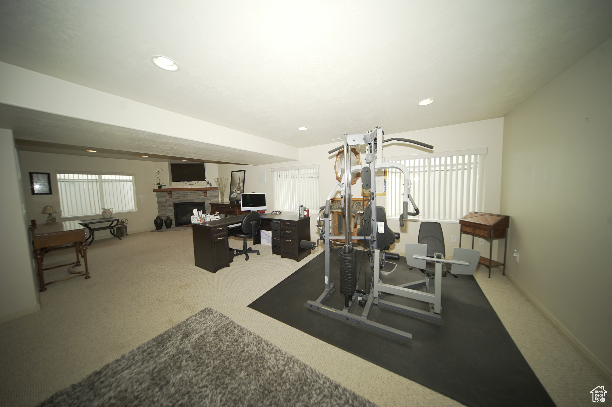 Workout room featuring carpet flooring and a fireplace