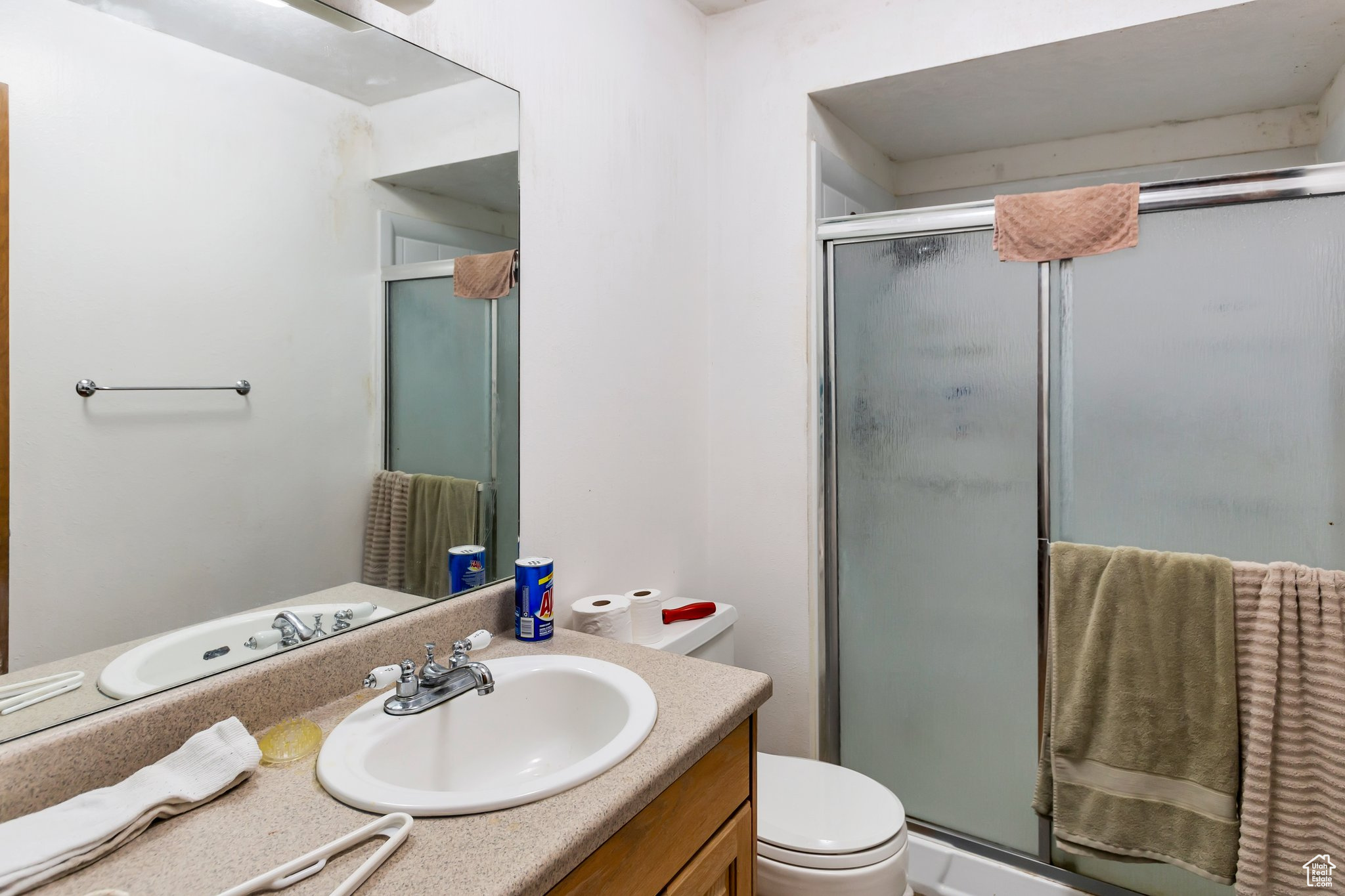 Main Bathroom with oversized vanity, an enclosed shower, and toilet