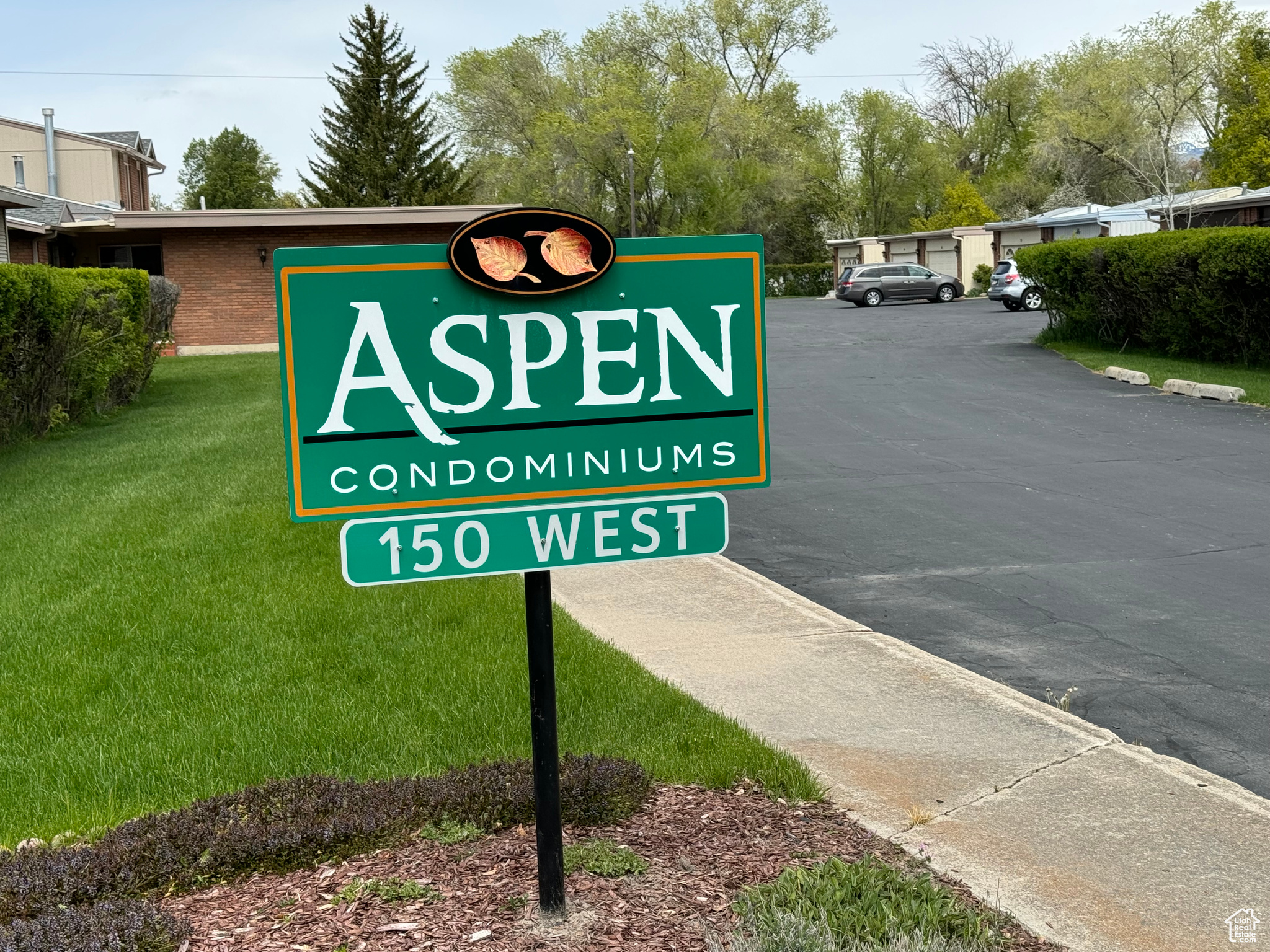 Community / neighborhood sign with a yard