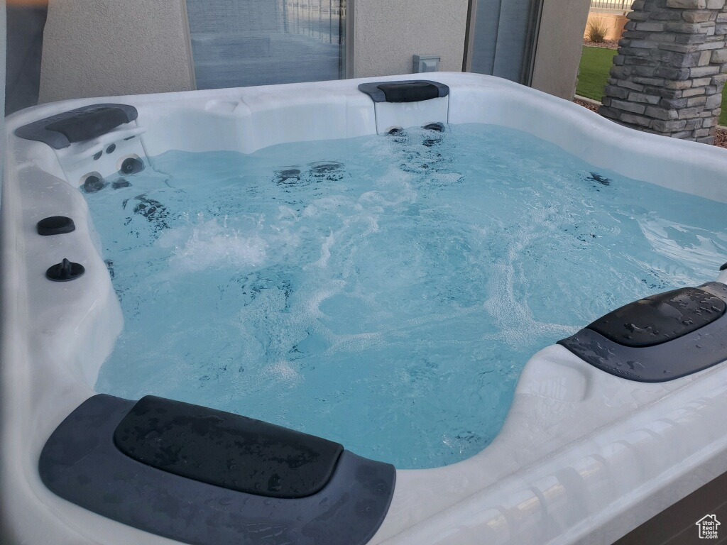 View of swimming pool featuring a hot tub