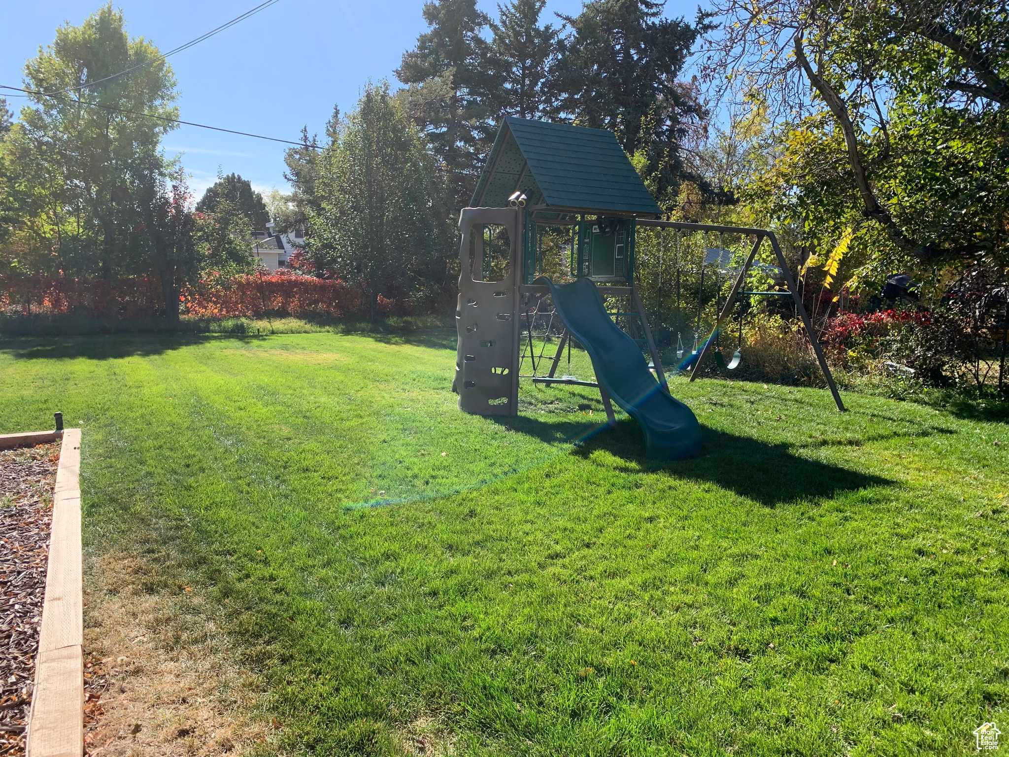 View of playground with a lawn