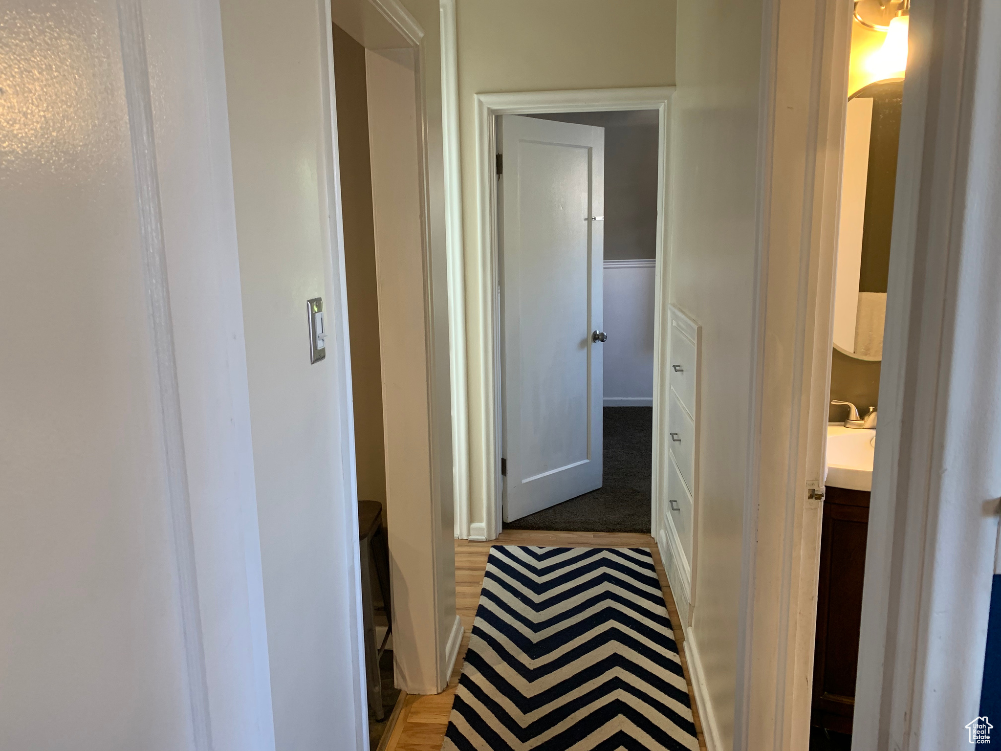 Corridor with sink and carpet