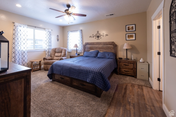 Bedroom featuring hardwood / wood-style floors and ceiling fan