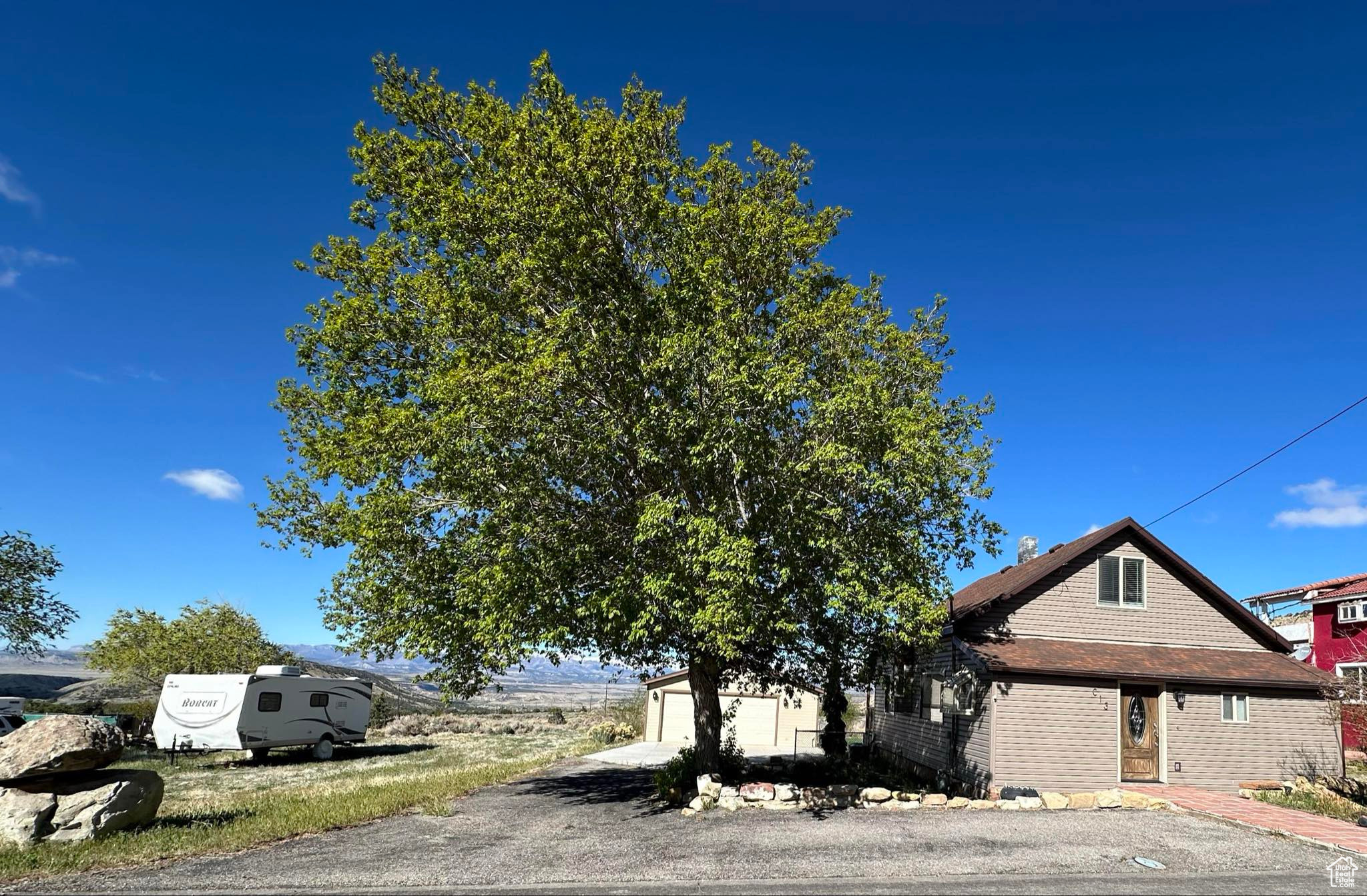 Obstructed view of property with an outdoor structure and a garage