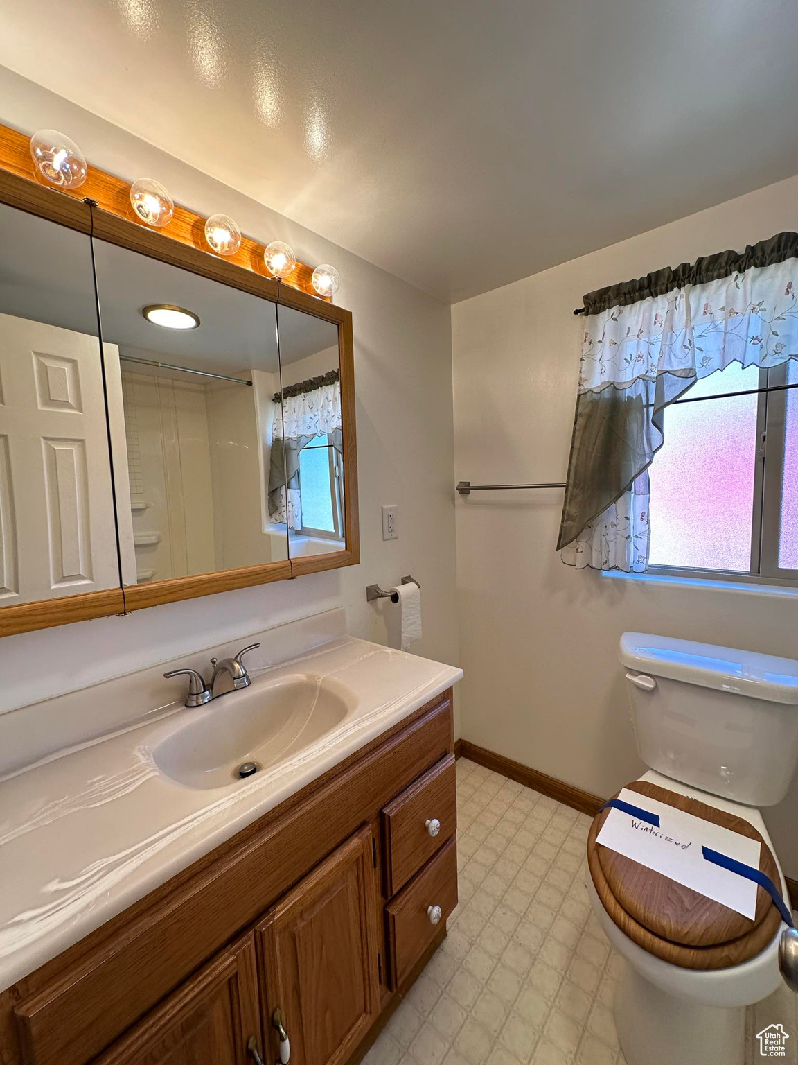 Bathroom featuring tile flooring, vanity, and toilet