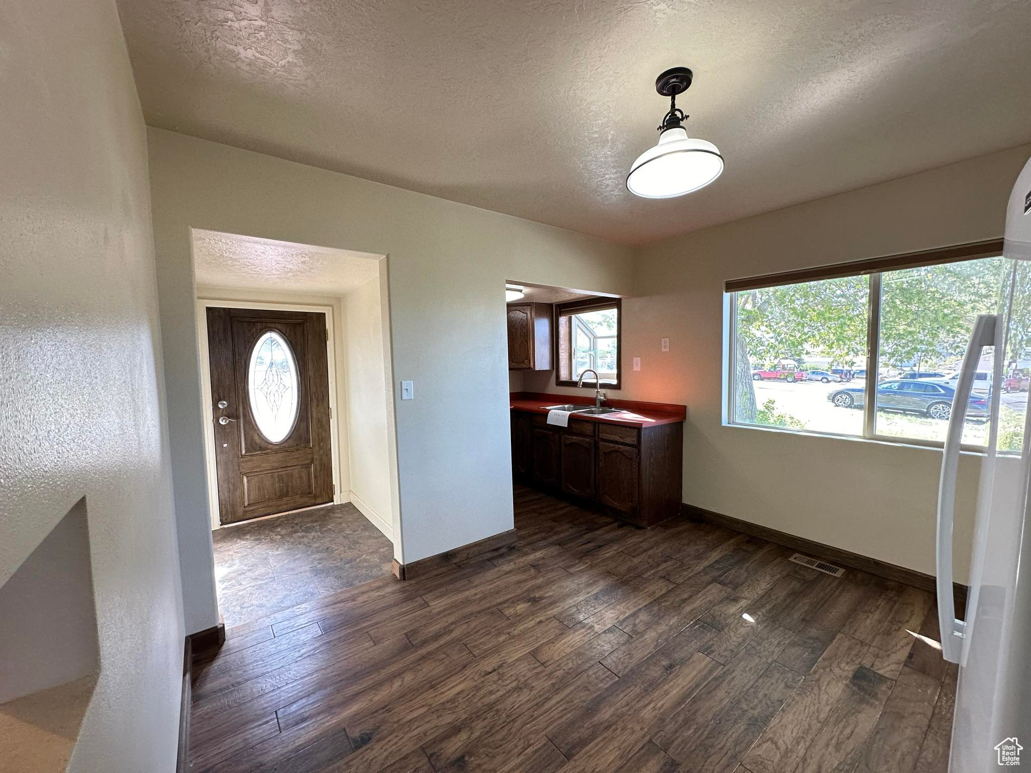 Foyer featuring dark hardwood / wood-style floors, sink, and a textured ceiling