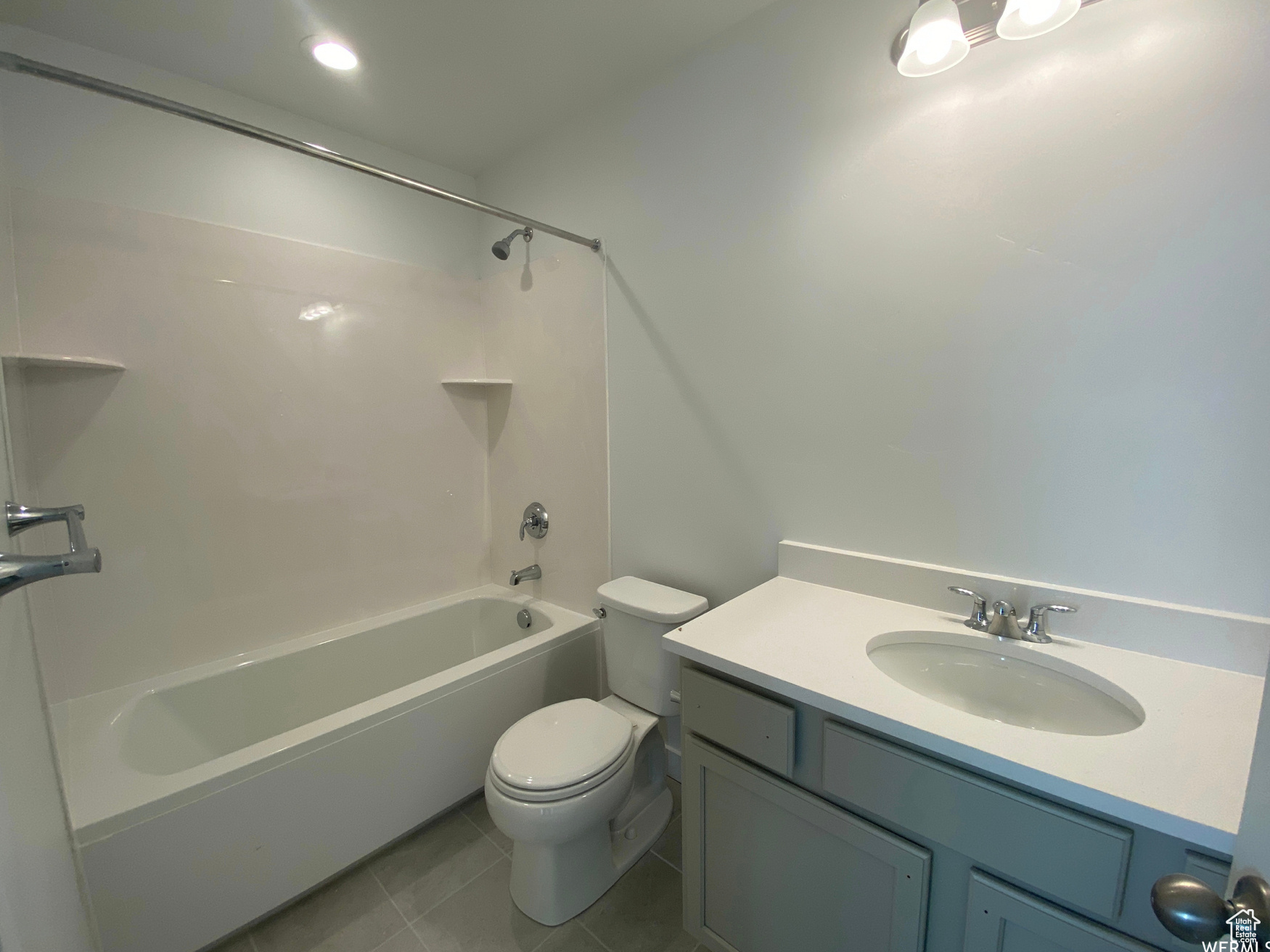 (previously built home as example) bathroom featuring shower / bath combination, vanity, tile floors, and toilet
