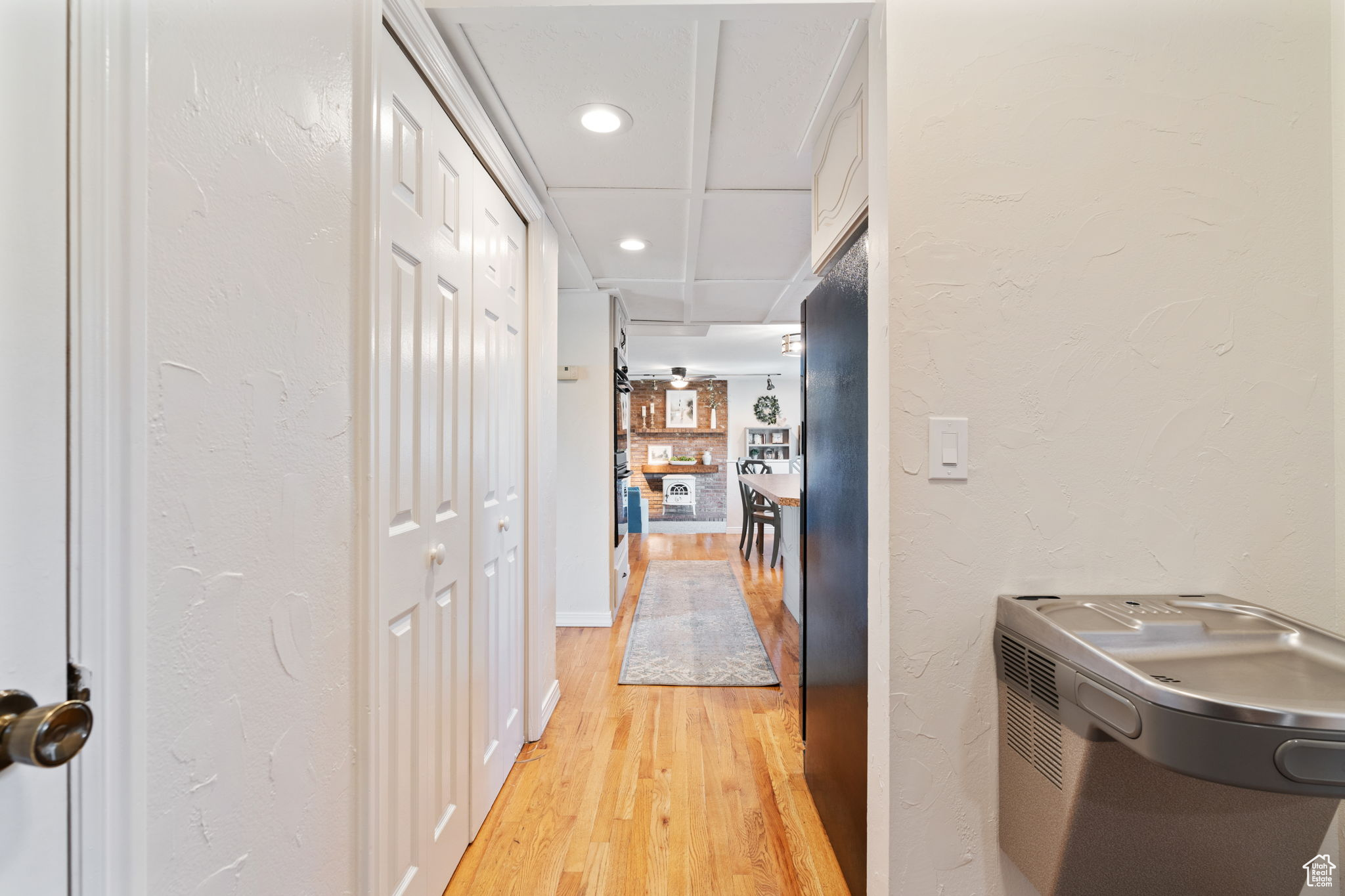 Corridor featuring light hardwood / wood-style flooring and drinking fountain