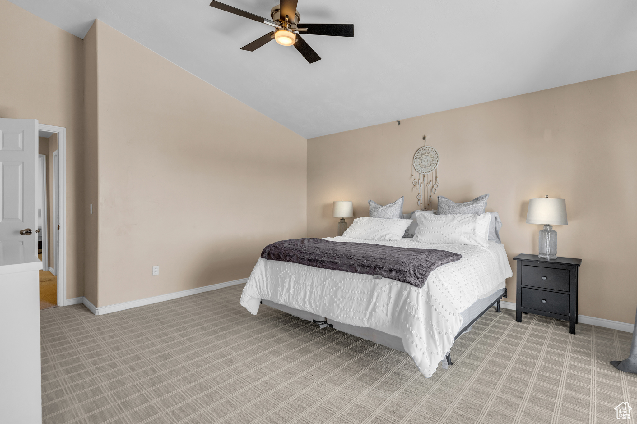 Carpeted bedroom featuring high vaulted ceiling and ceiling fan