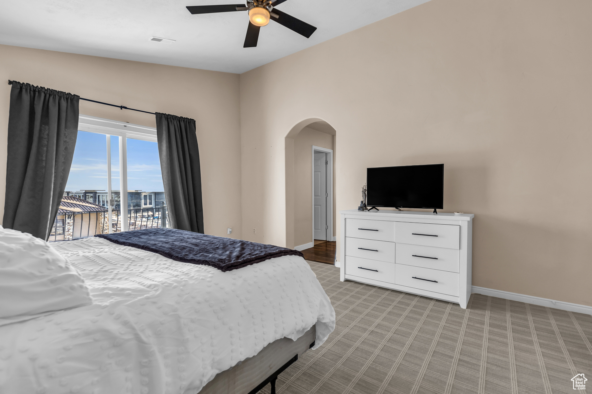 Bedroom with access to outside, ceiling fan, and vaulted ceiling