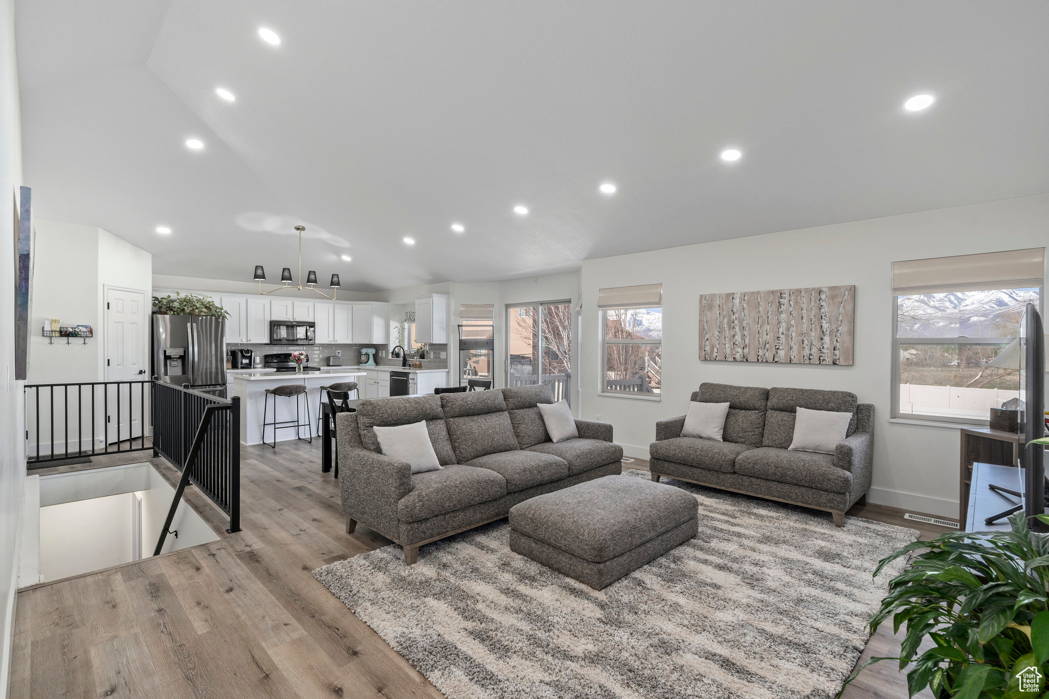 Family room featuring high vaulted ceiling and light flooring