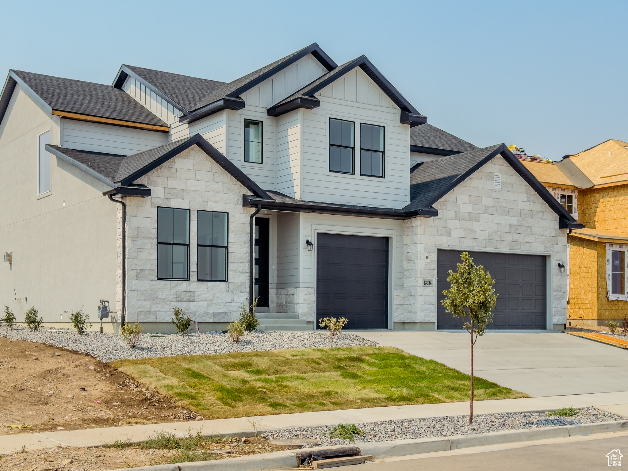 Craftsman-style home featuring a front yard and a garage