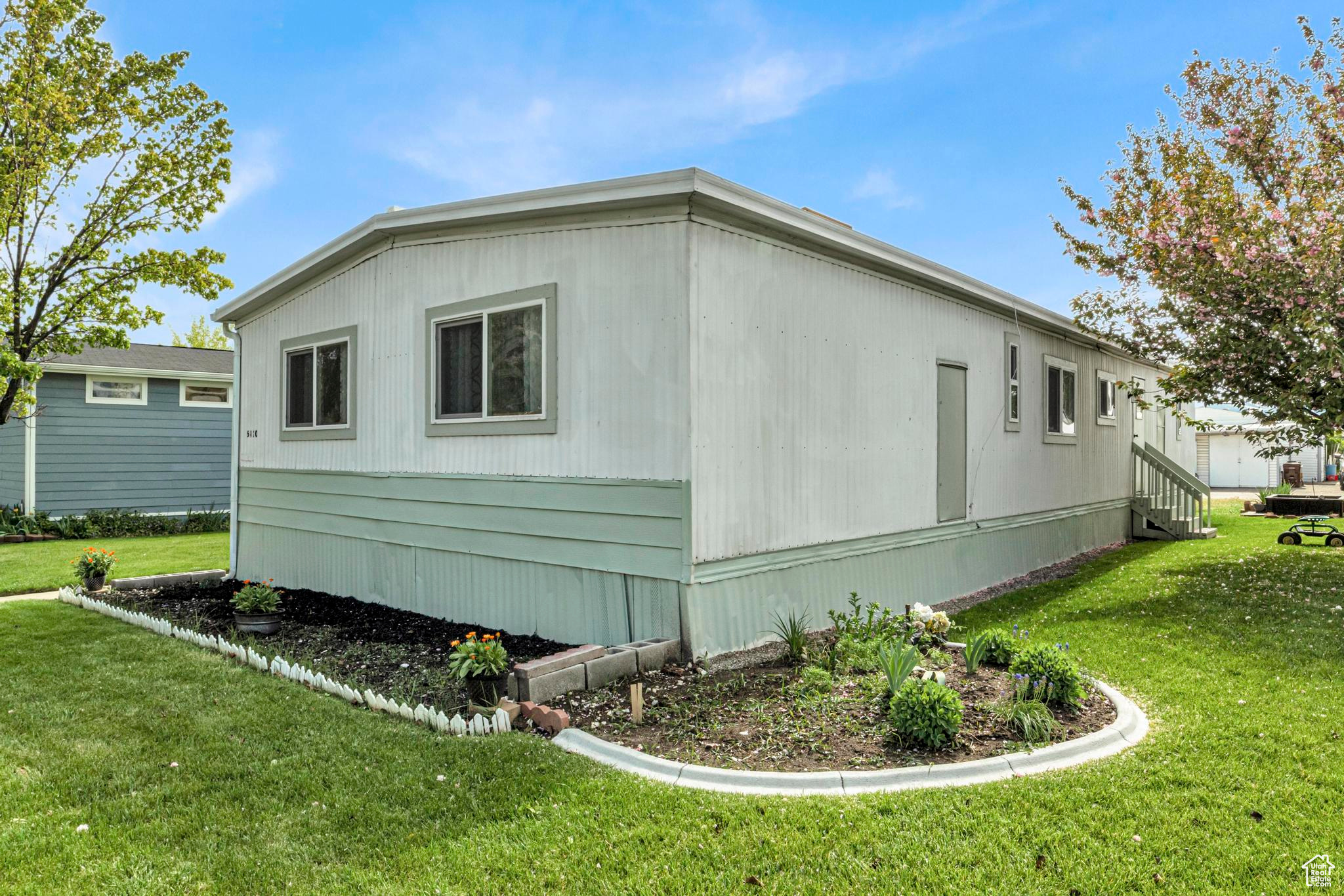 View of side of home featuring a lawn