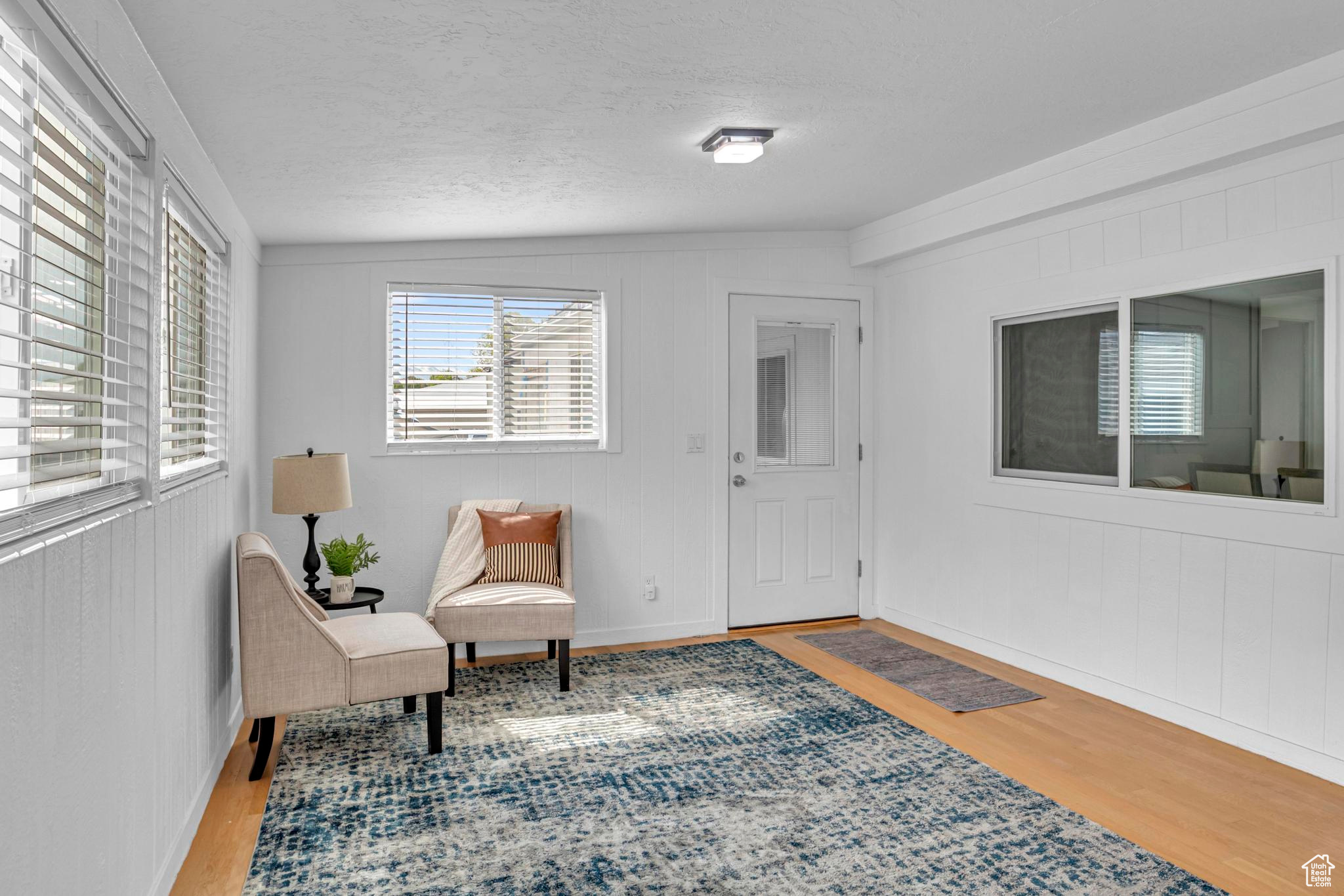 Living area with hardwood / wood-style floors and vaulted ceiling