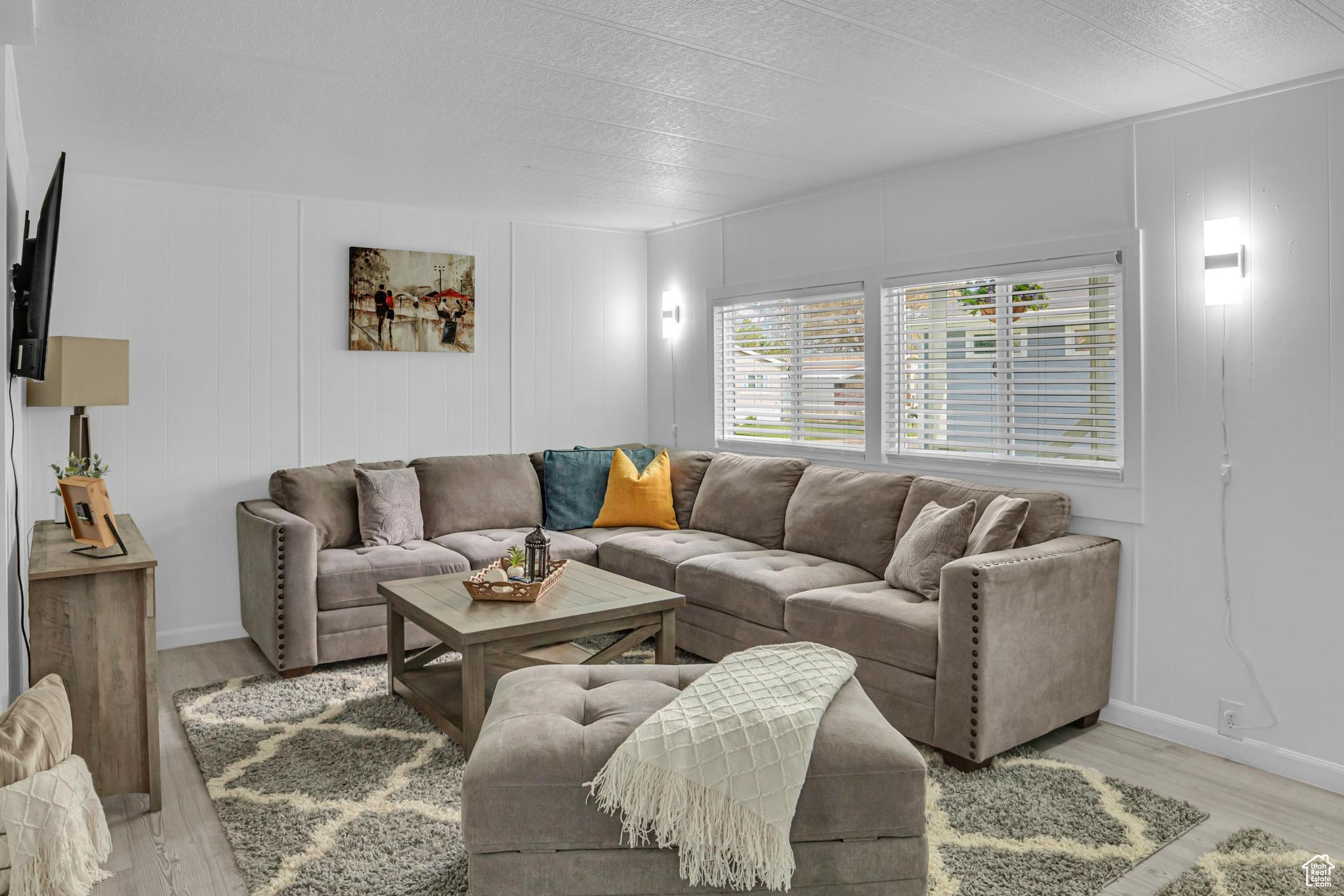 Living room with light hardwood / wood-style flooring and a textured ceiling