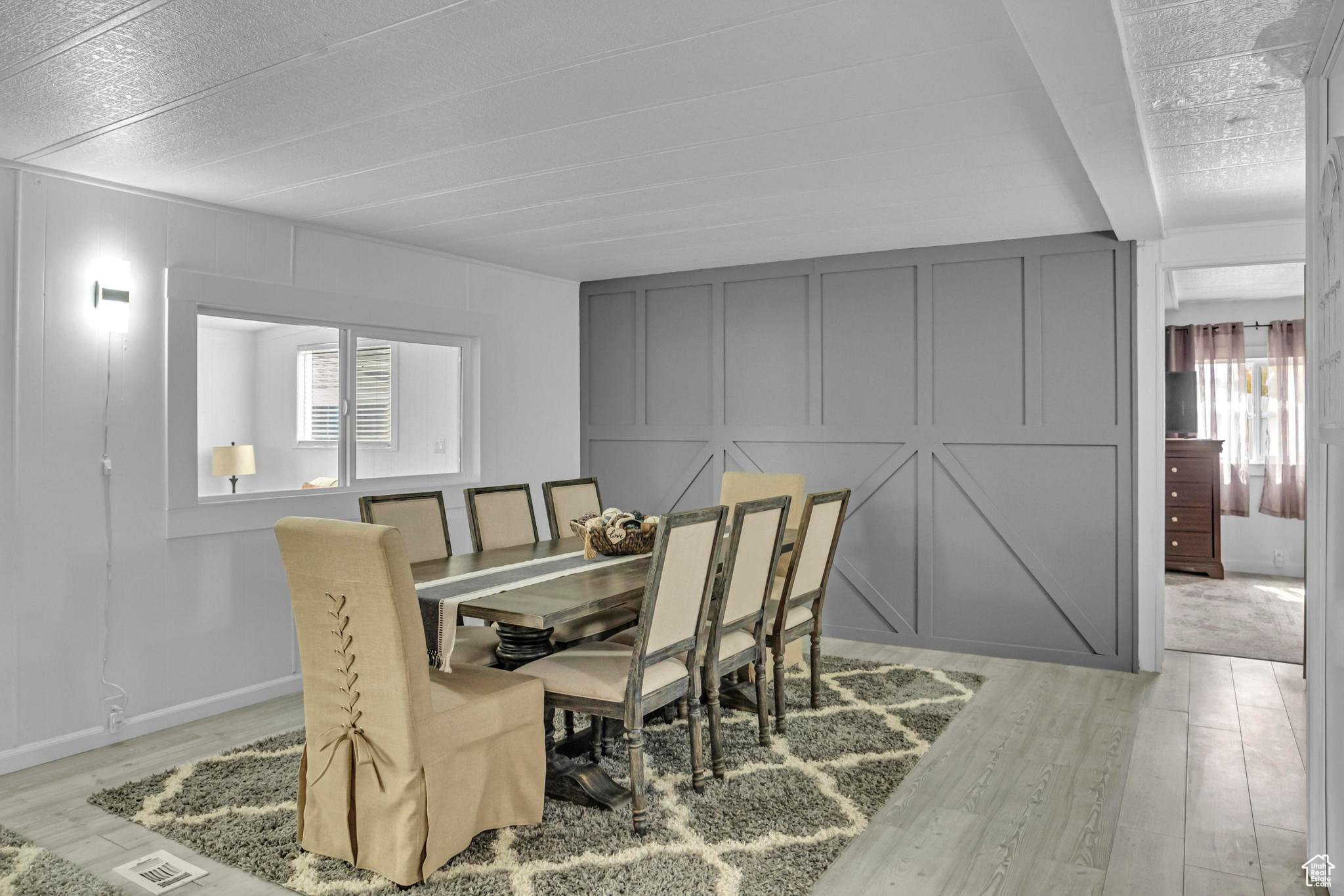 Dining area featuring light hardwood / wood-style floors and a textured ceiling