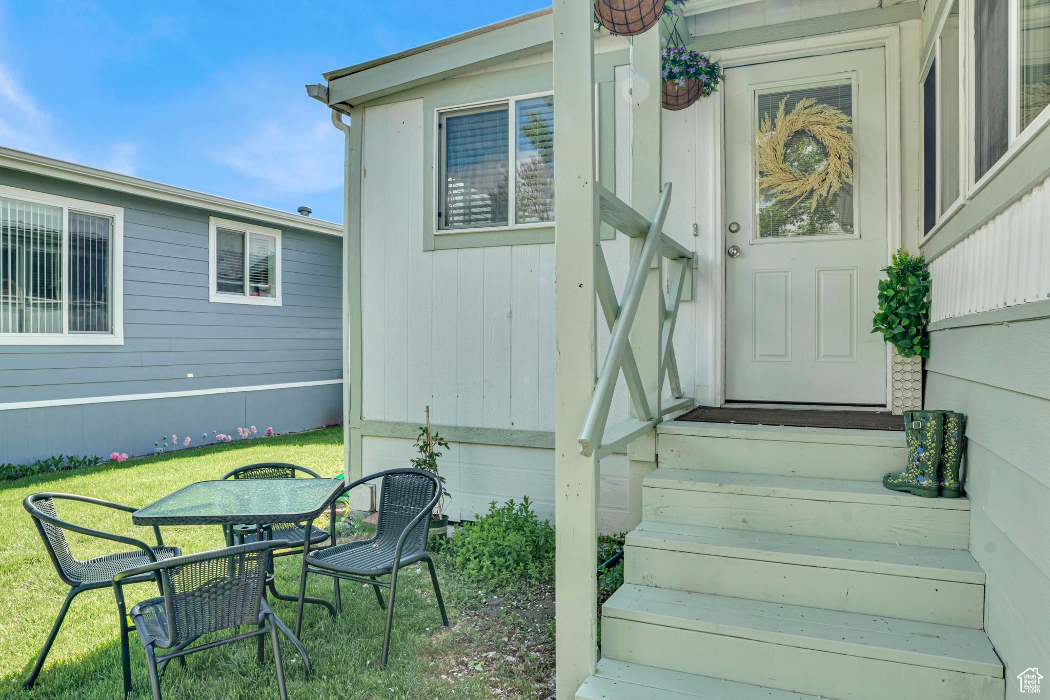 Entrance to property featuring a lawn